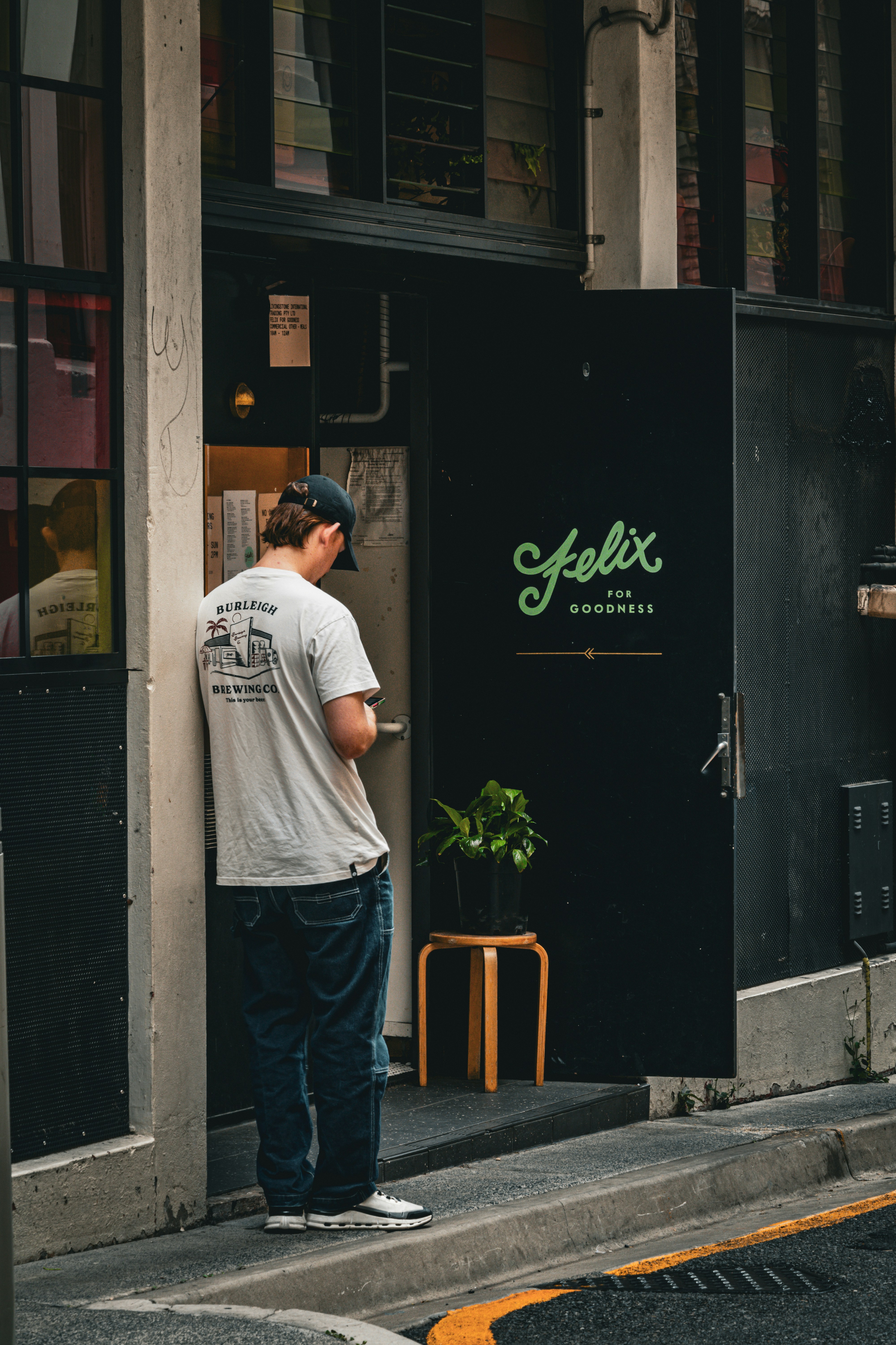A man is standing outside of a restaurant