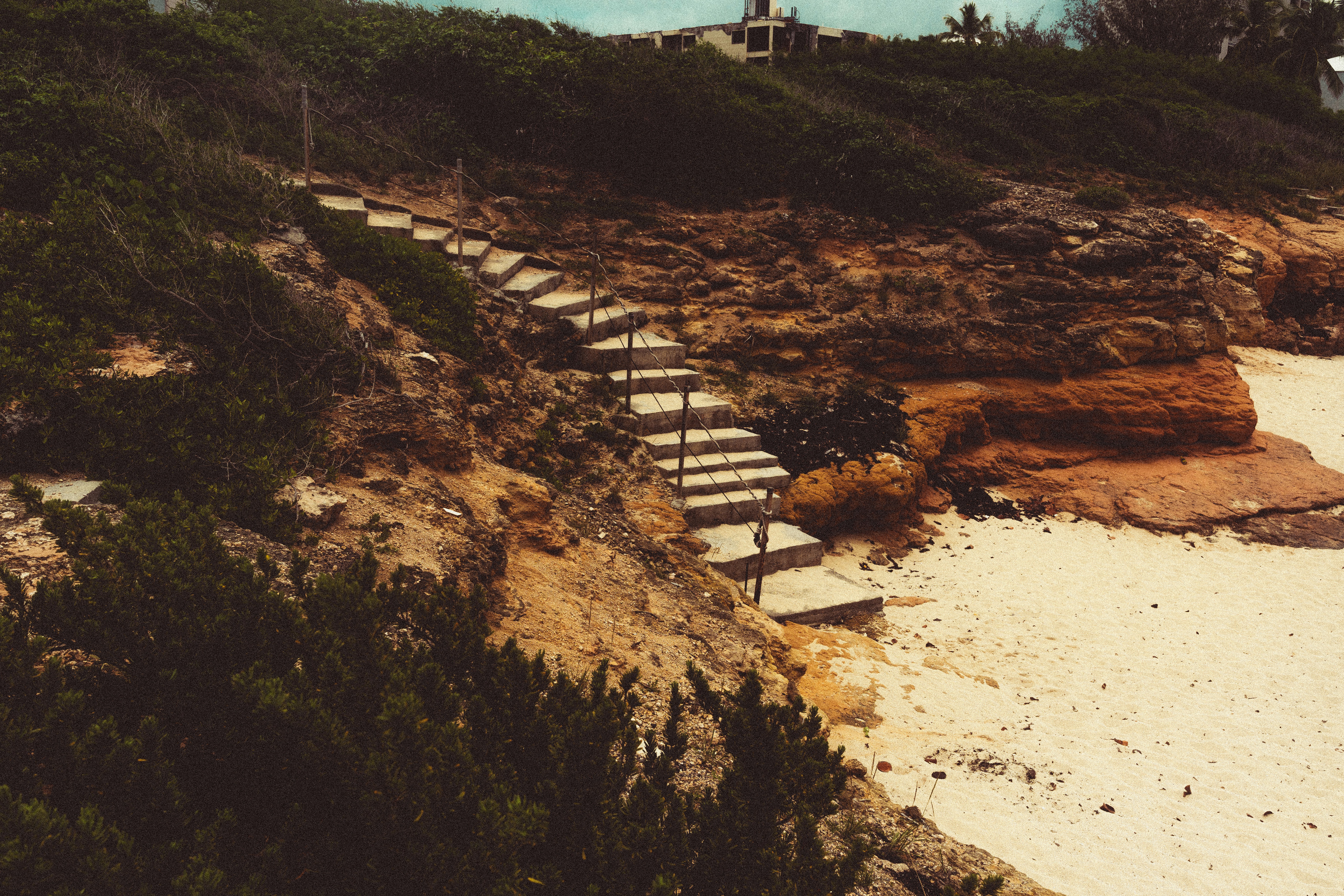 A beach with steps leading to a lighthouse, 