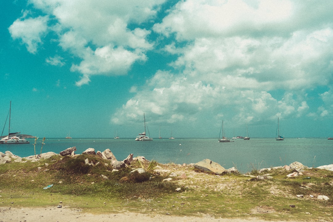 A group of boats floating on top of a body of water,