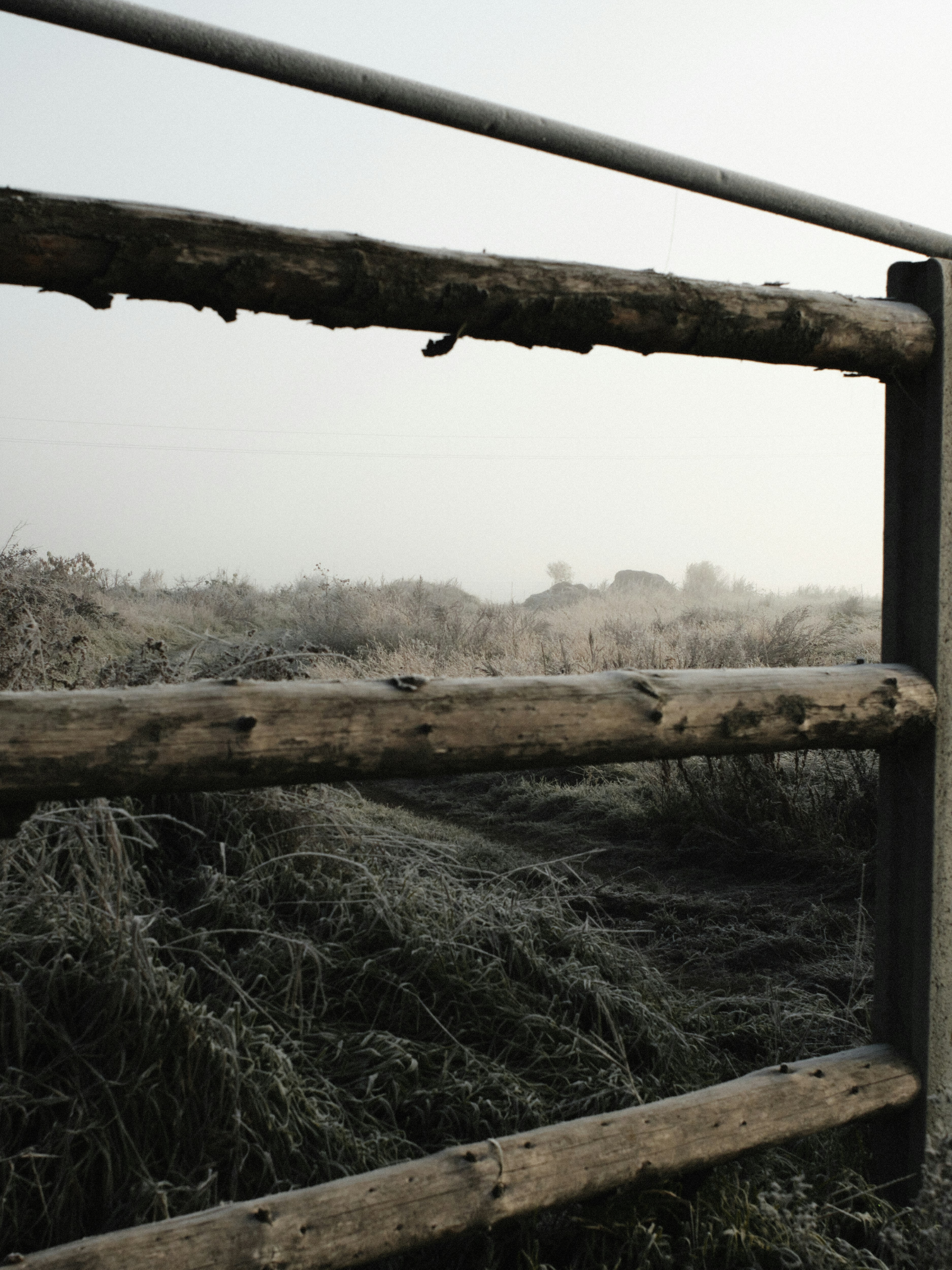 A wooden fence in the middle of a field