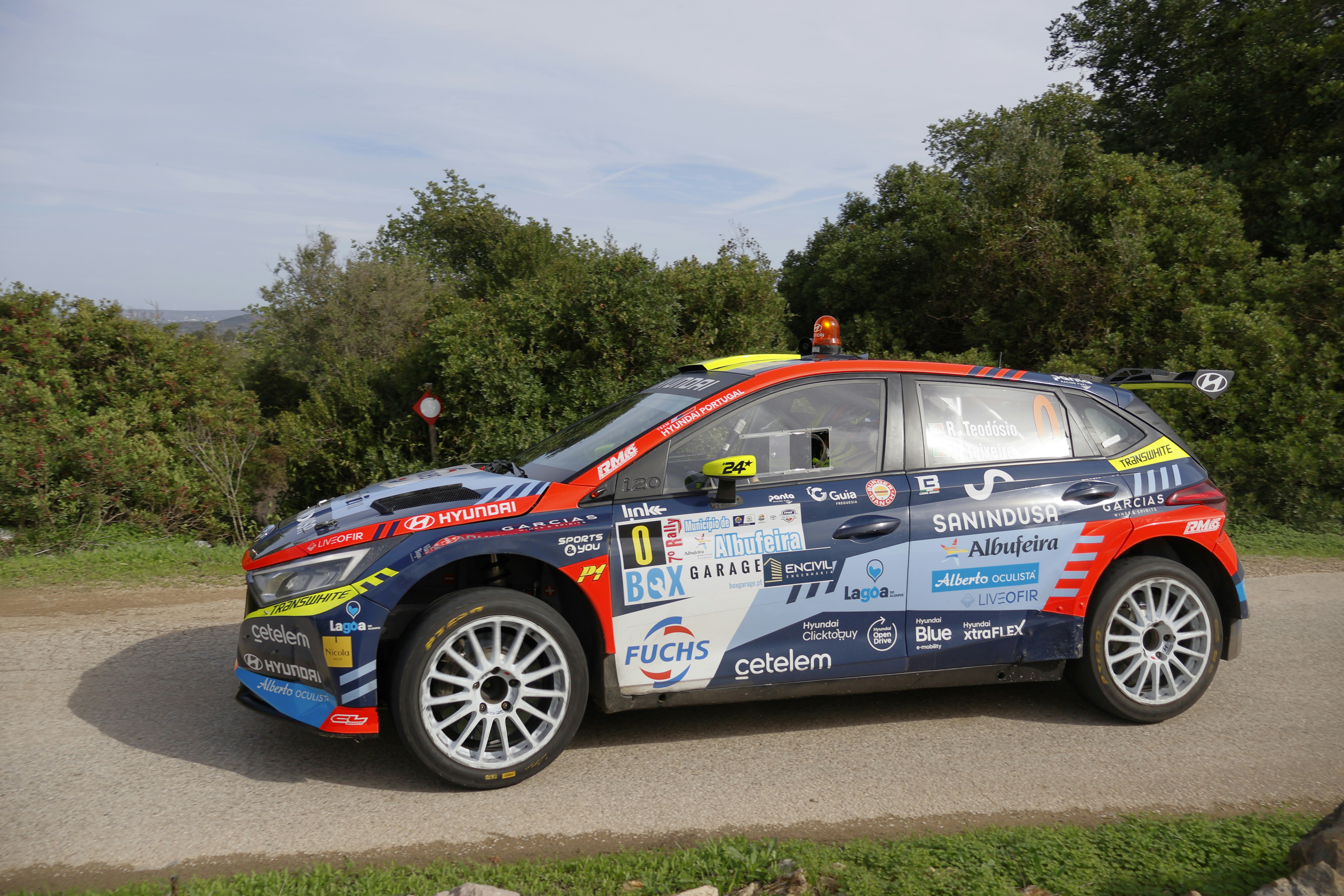 A car with a colorful paint job parked on the side of a road