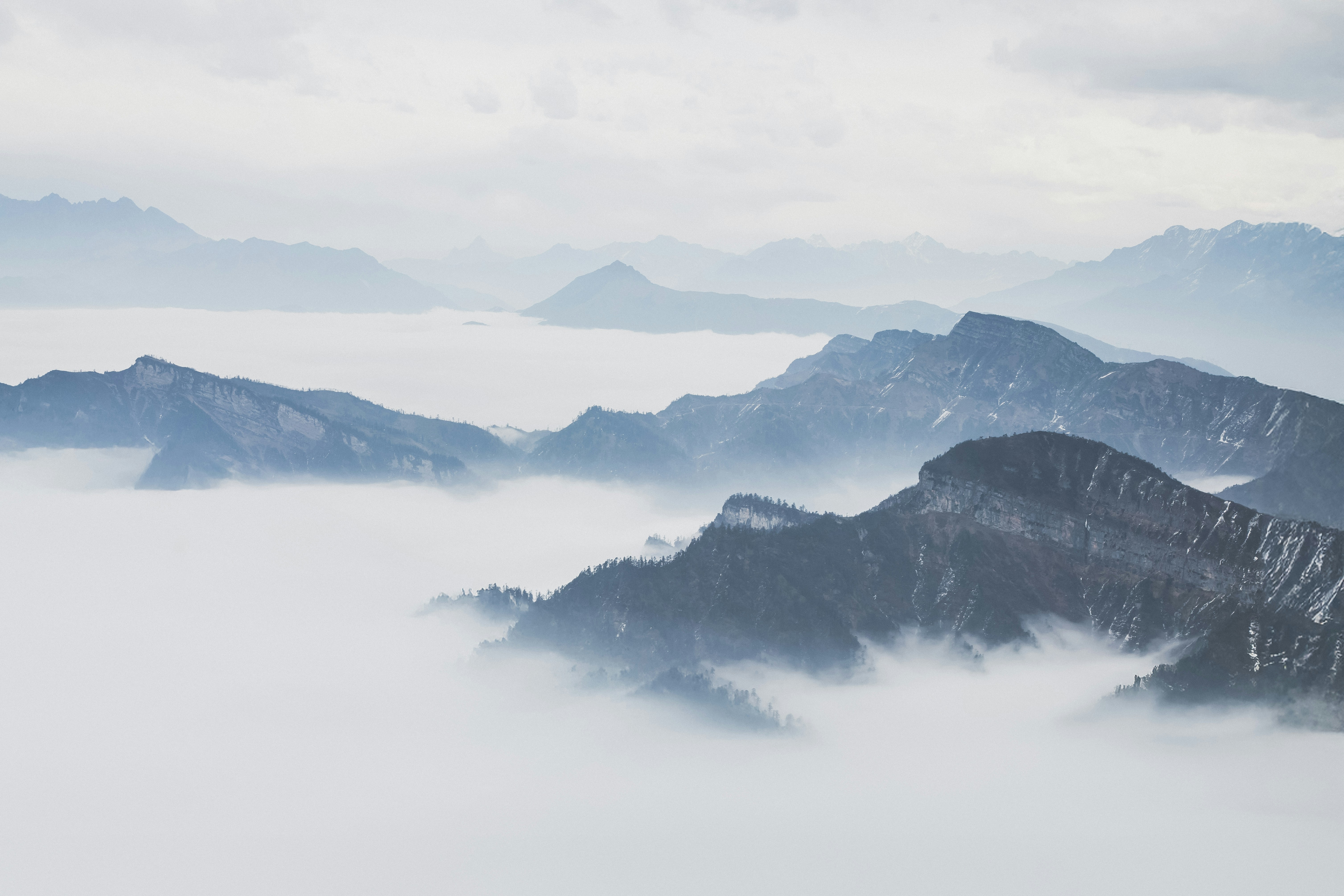 A view of a mountain range covered in fog