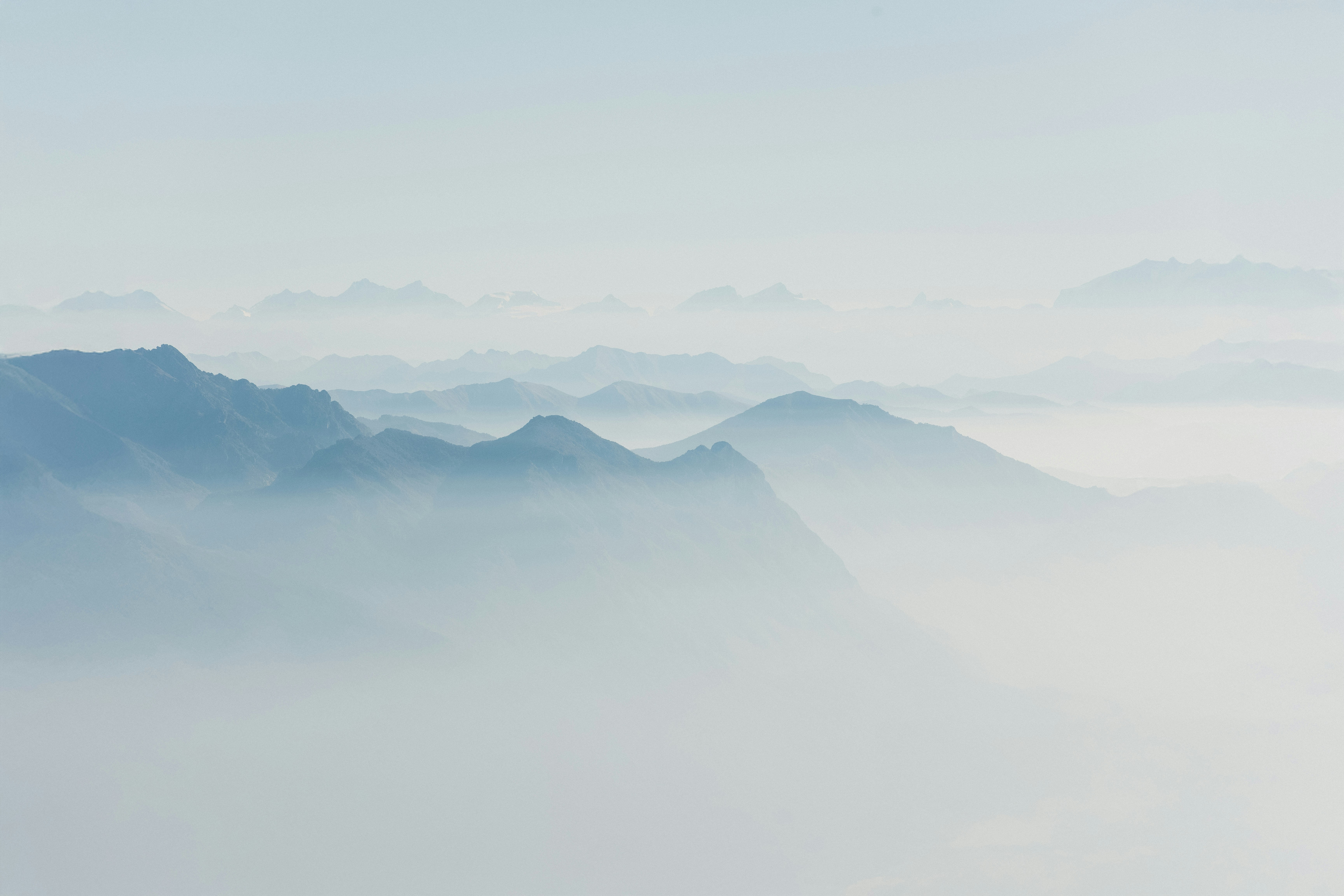 A view of a mountain range covered in fog