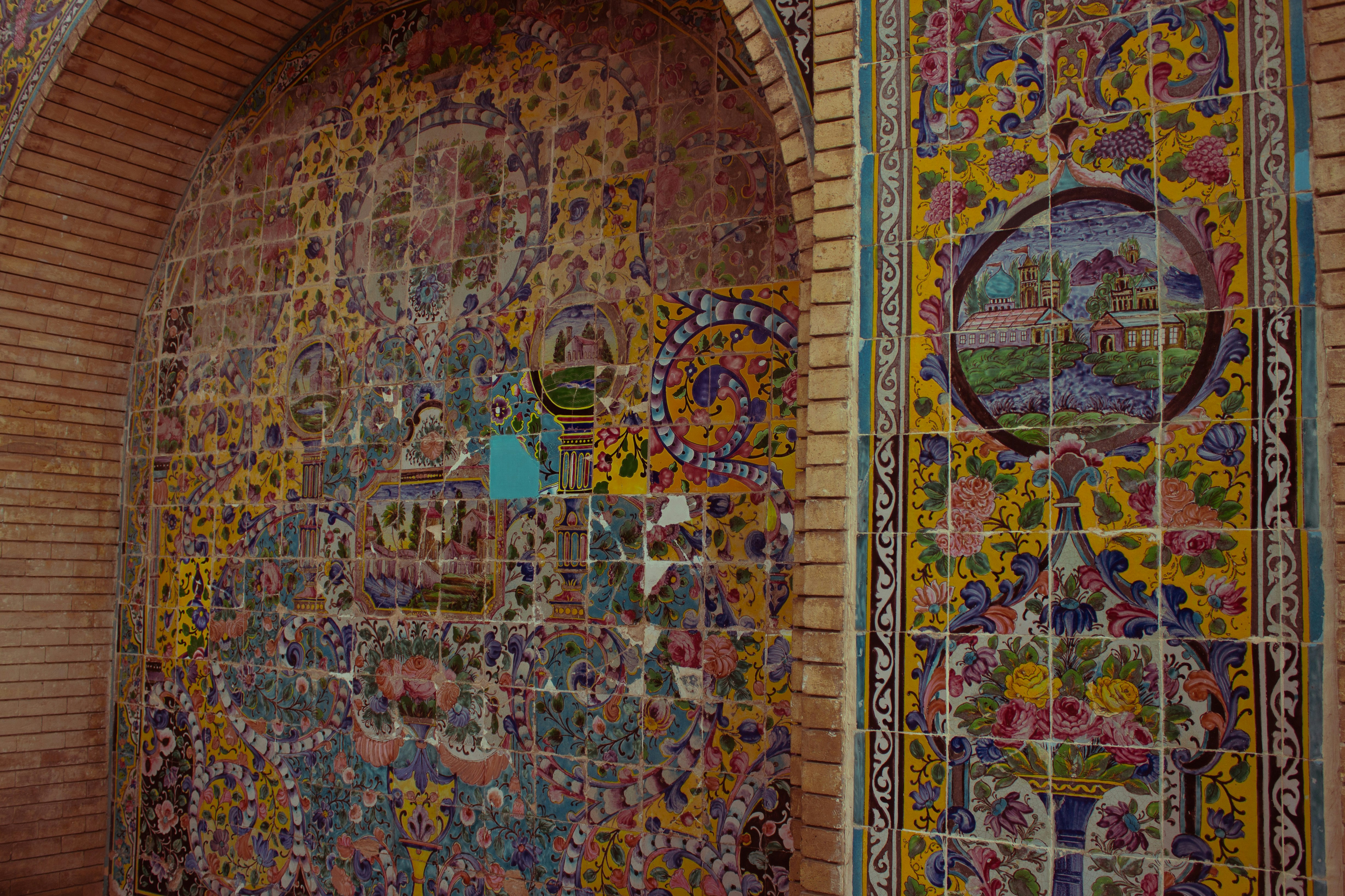 A wall covered in lots of different colored tiles