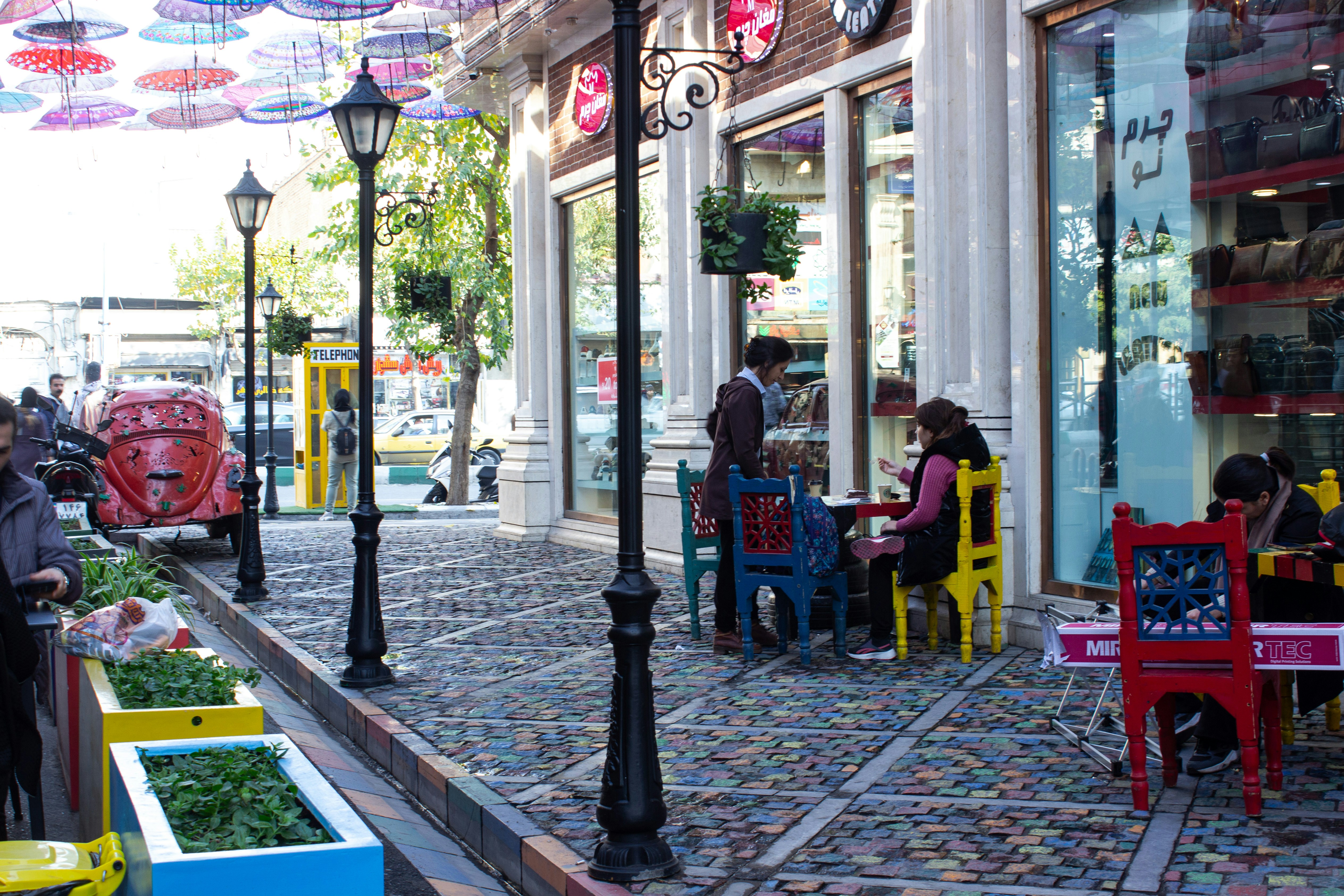 vibrant neighborhood street with boutiques and outdoor cafes - upscale apartments near me