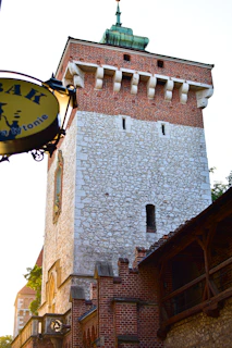 A tall brick tower with a clock on it's side