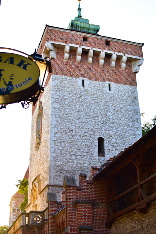 A tall brick tower with a clock on it's side