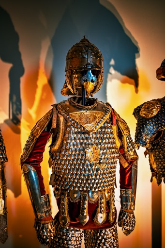 A group of armor and helmets on display in a museum