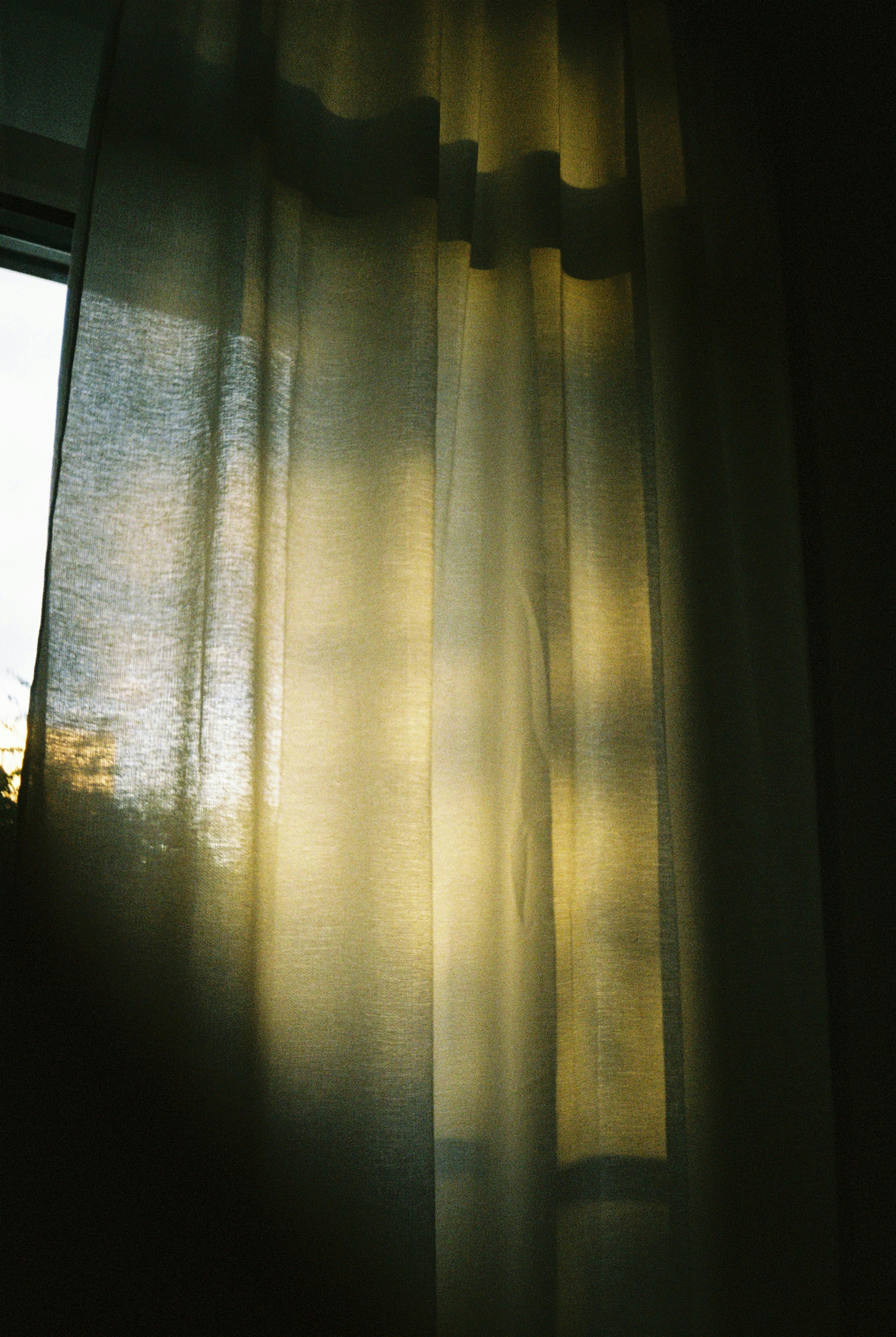 Sunlit room with soft diffused light through curtains, dust motes in the air, peaceful afternoon