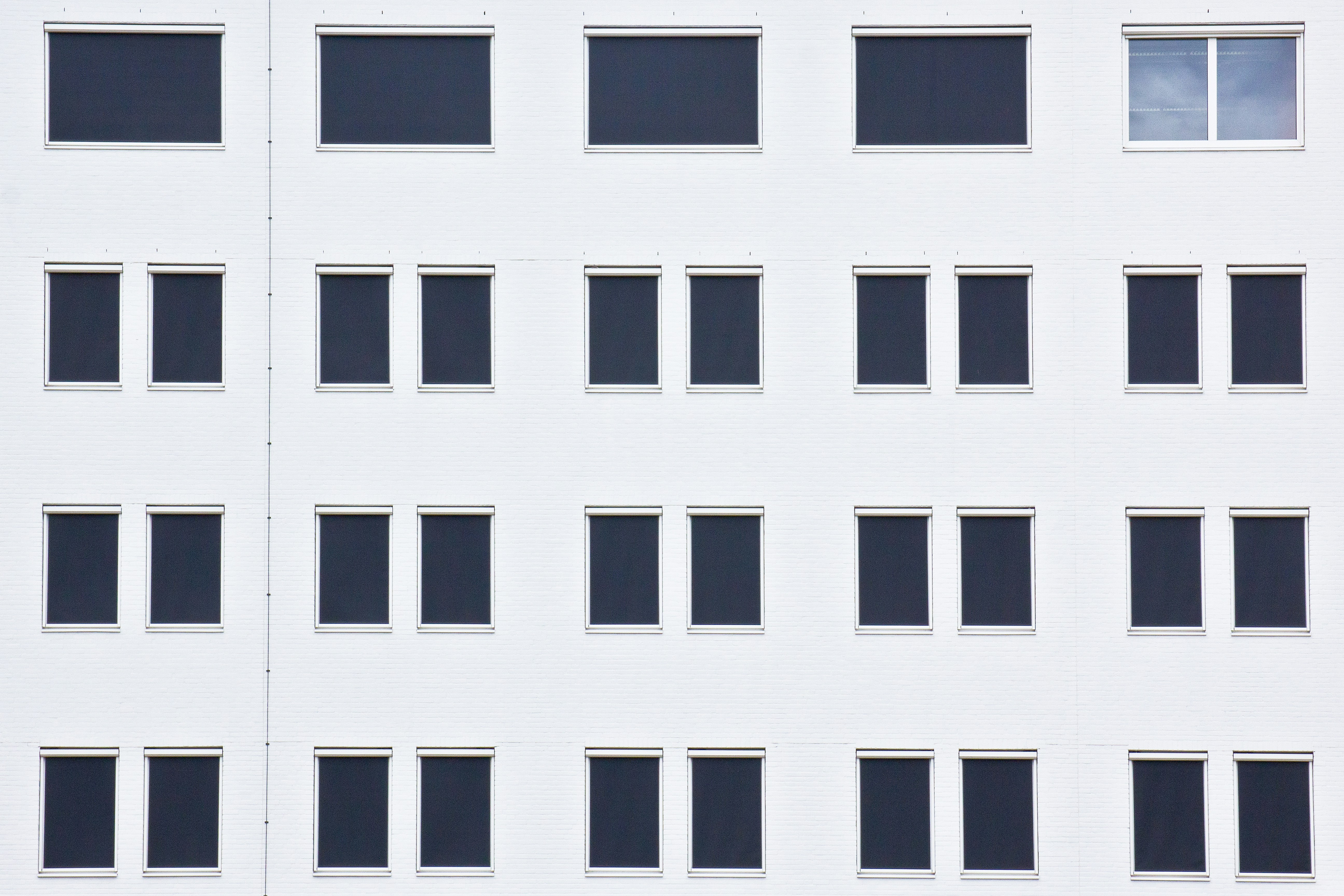 A tall white building with lots of windows