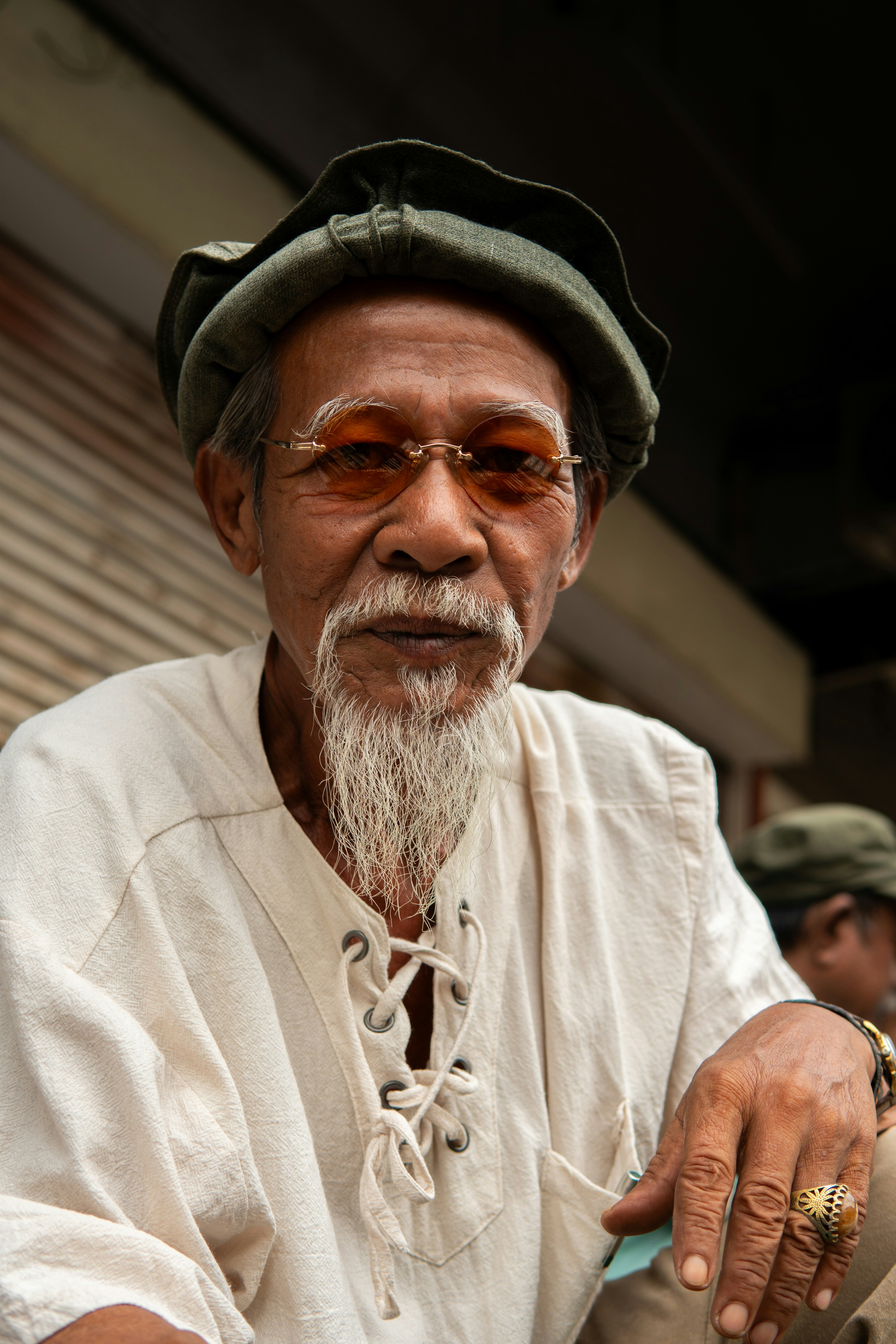 A man with a white beard wearing a hat and sunglasses