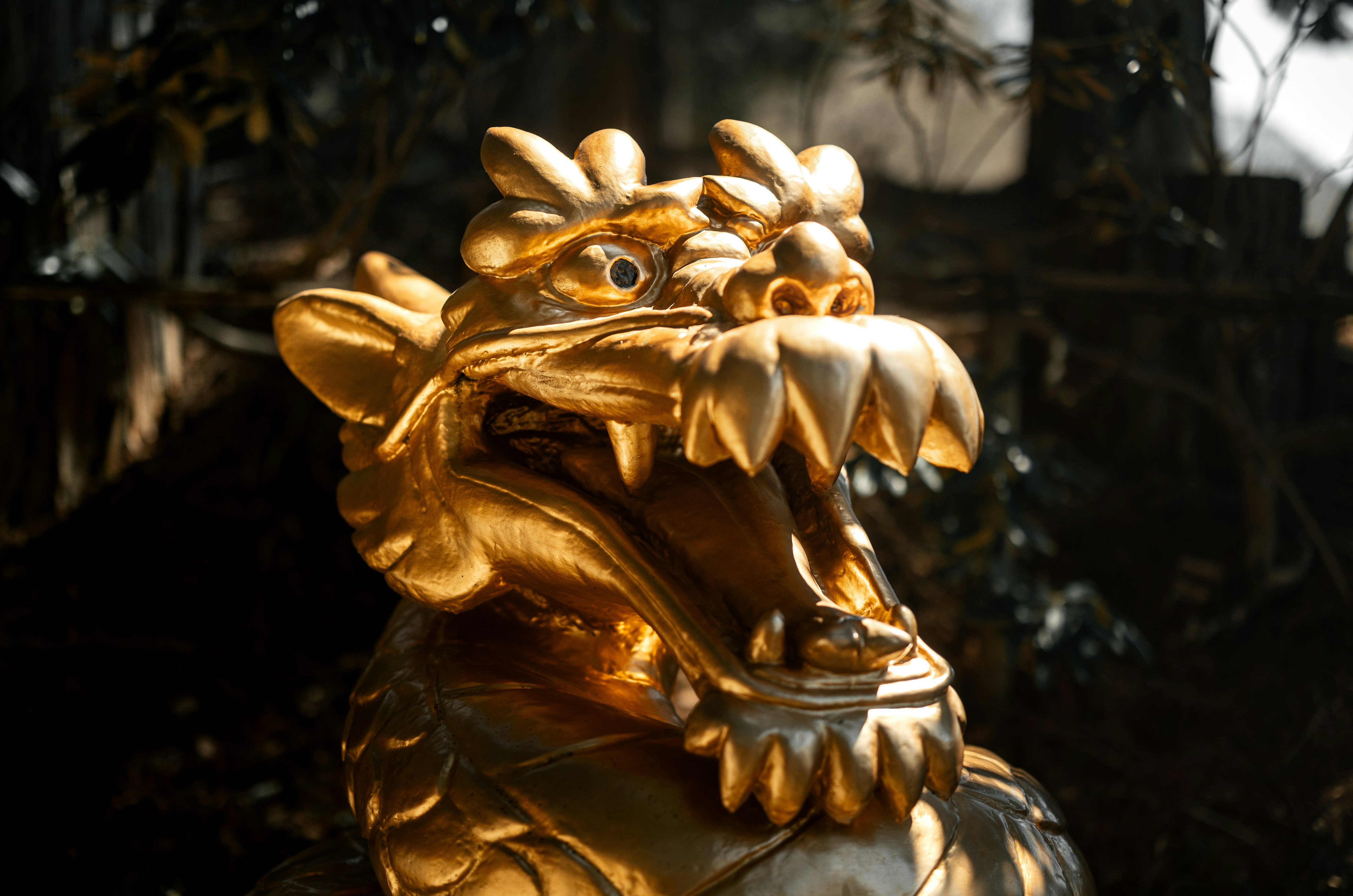 A golden statue of a dragon with its mouth open