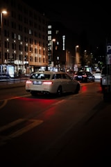 A car driving down a city street at night