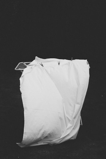 A black and white photo of a bag on the ground