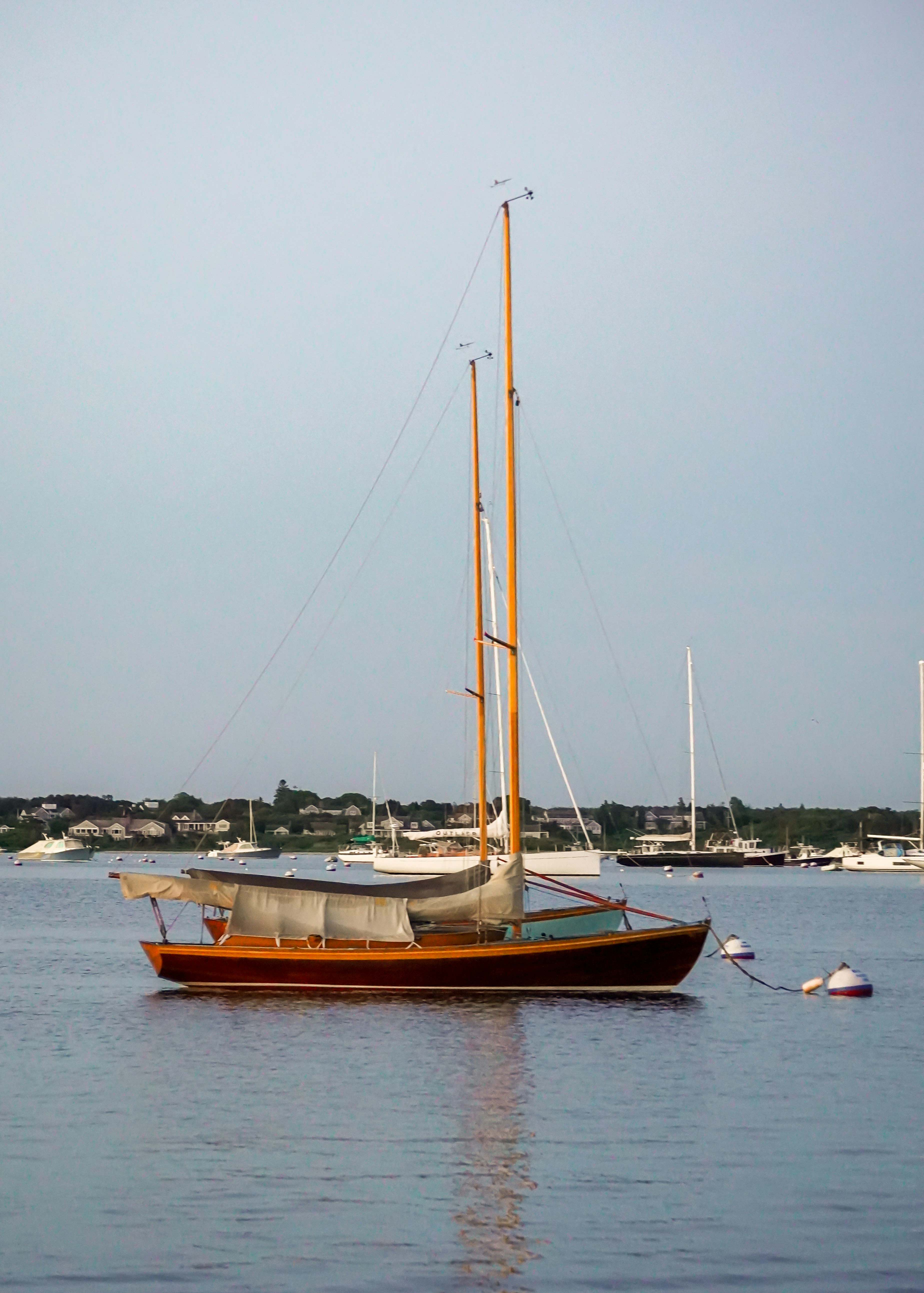 A sailboat floating in the middle of a body of water