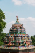 A colorfully painted building in the middle of a park