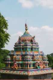 A colorfully painted building in the middle of a park