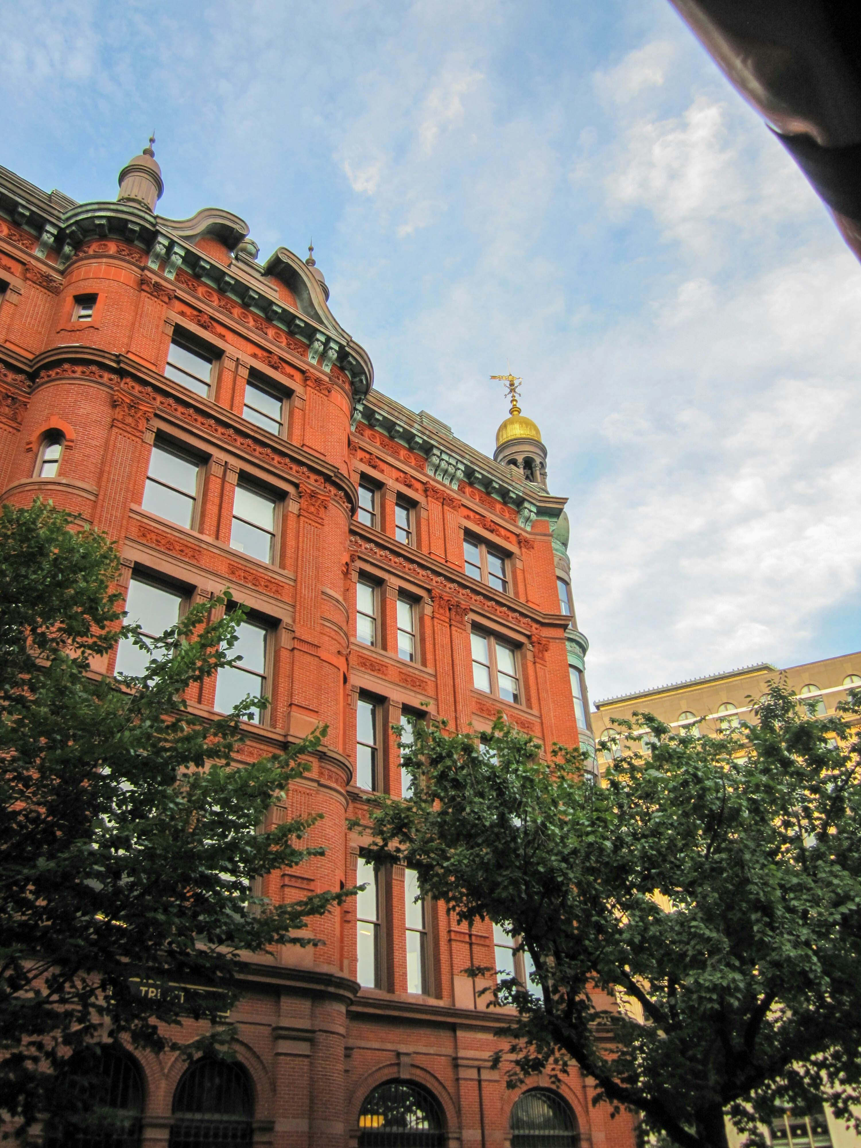 A large red building with a clock on the top of it