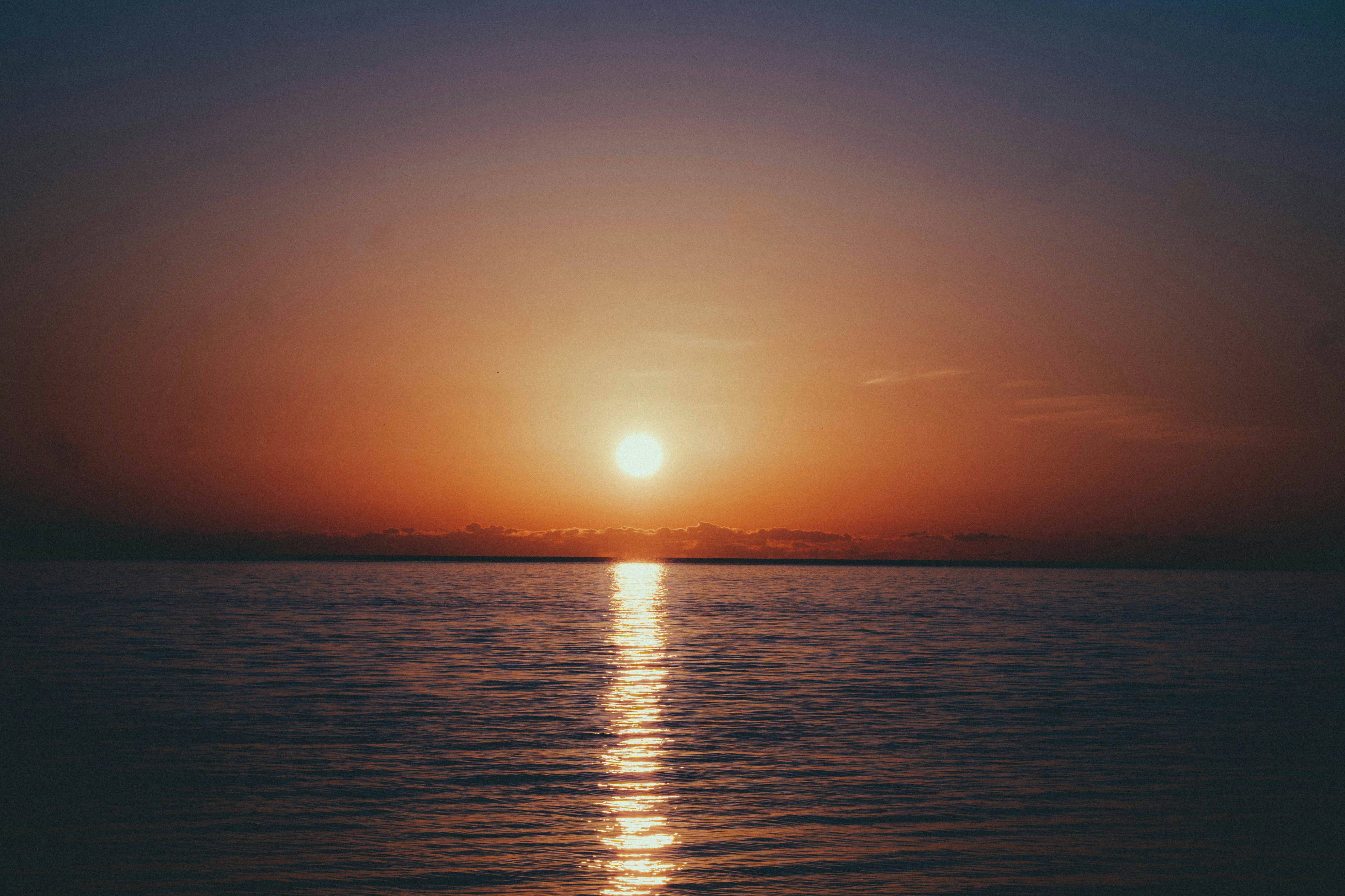 The sun is setting over the water