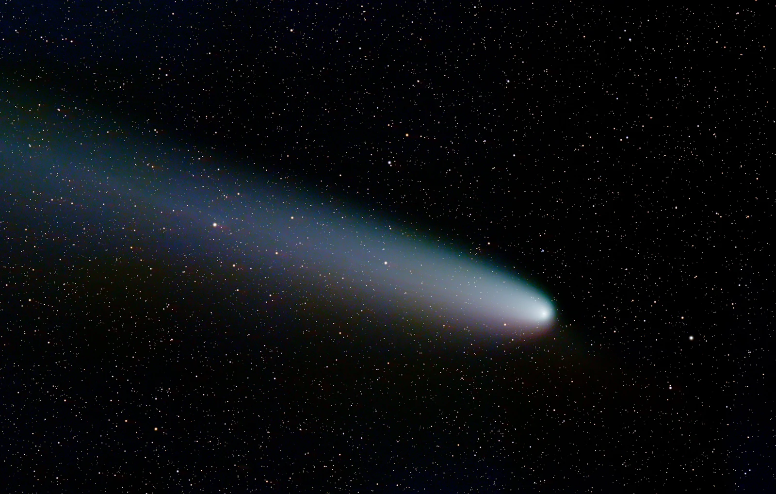 A comet with a glowing tail in the night sky