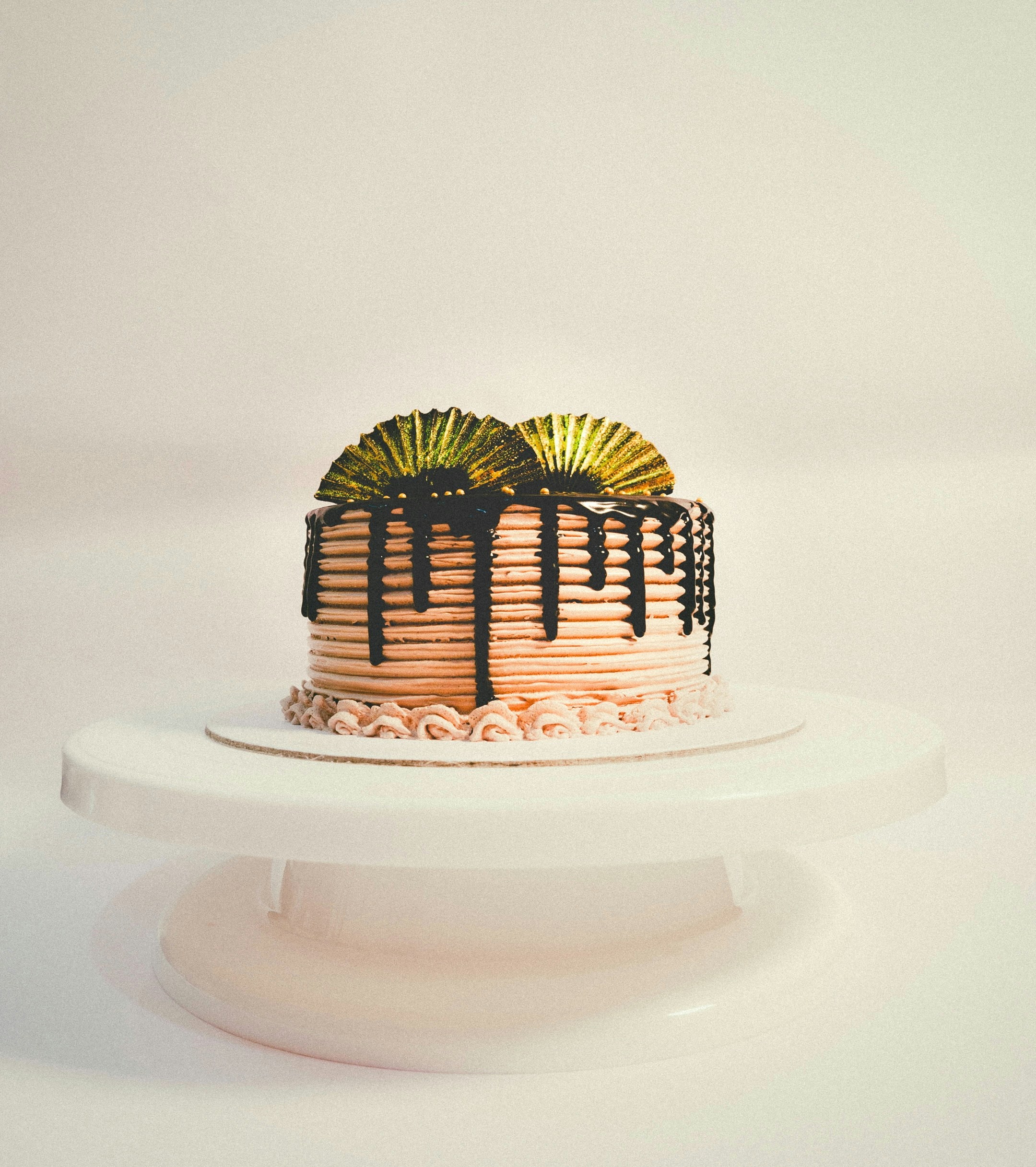 A white cake with chocolate icing and decorations