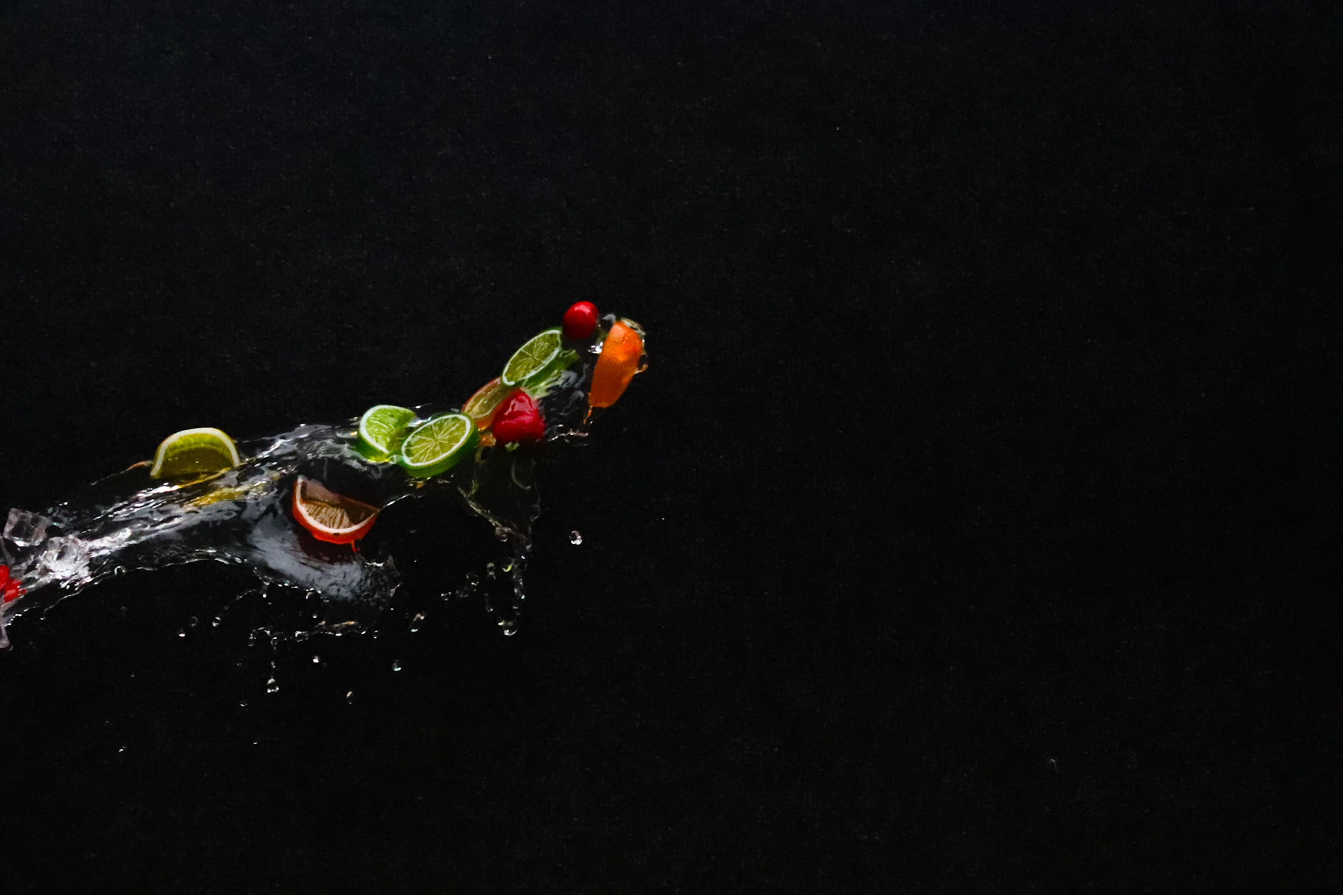 A group of fruit is being dropped into the water