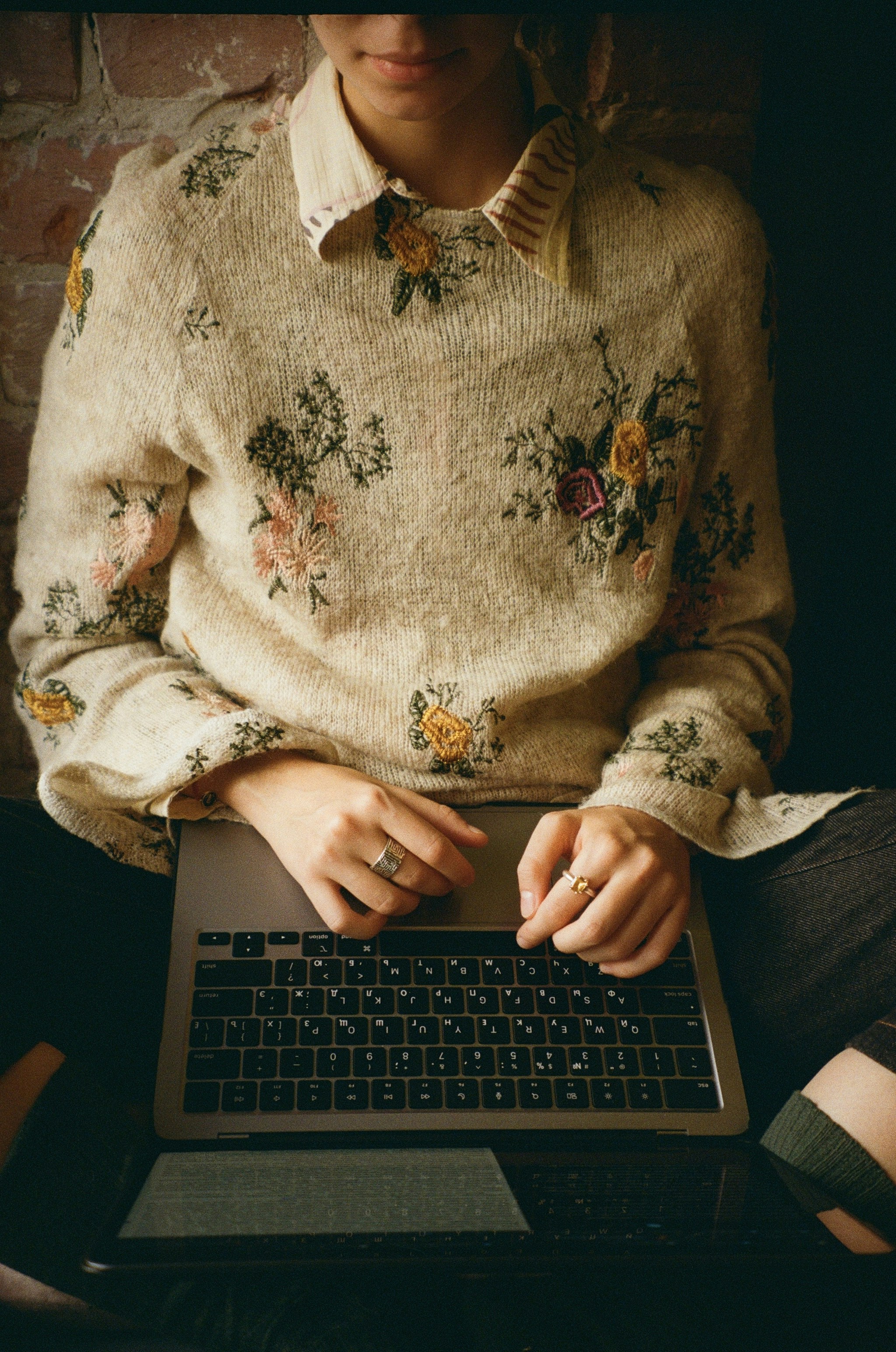 A woman sitting in front of a laptop computer