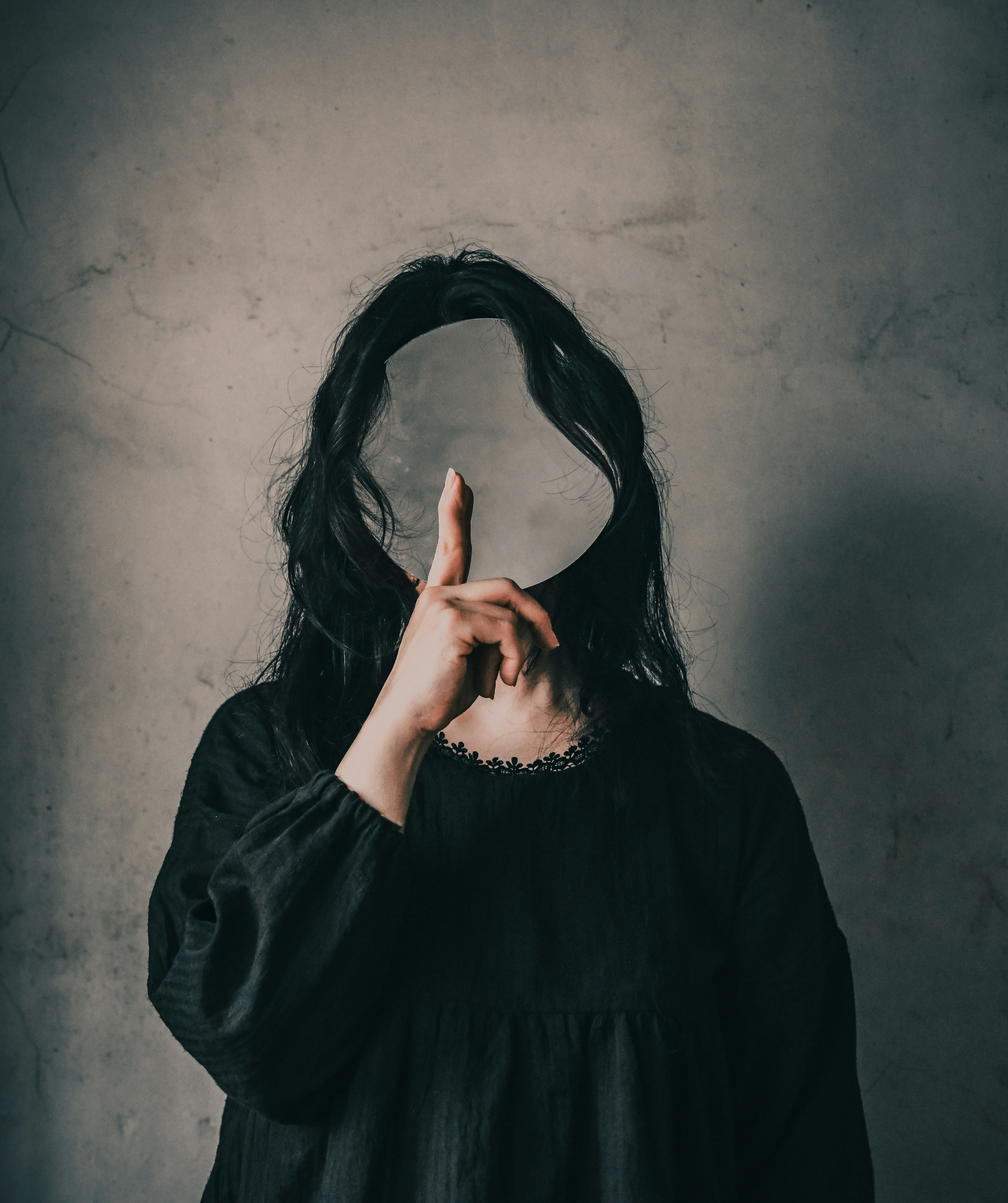 A woman with long hair covering her face