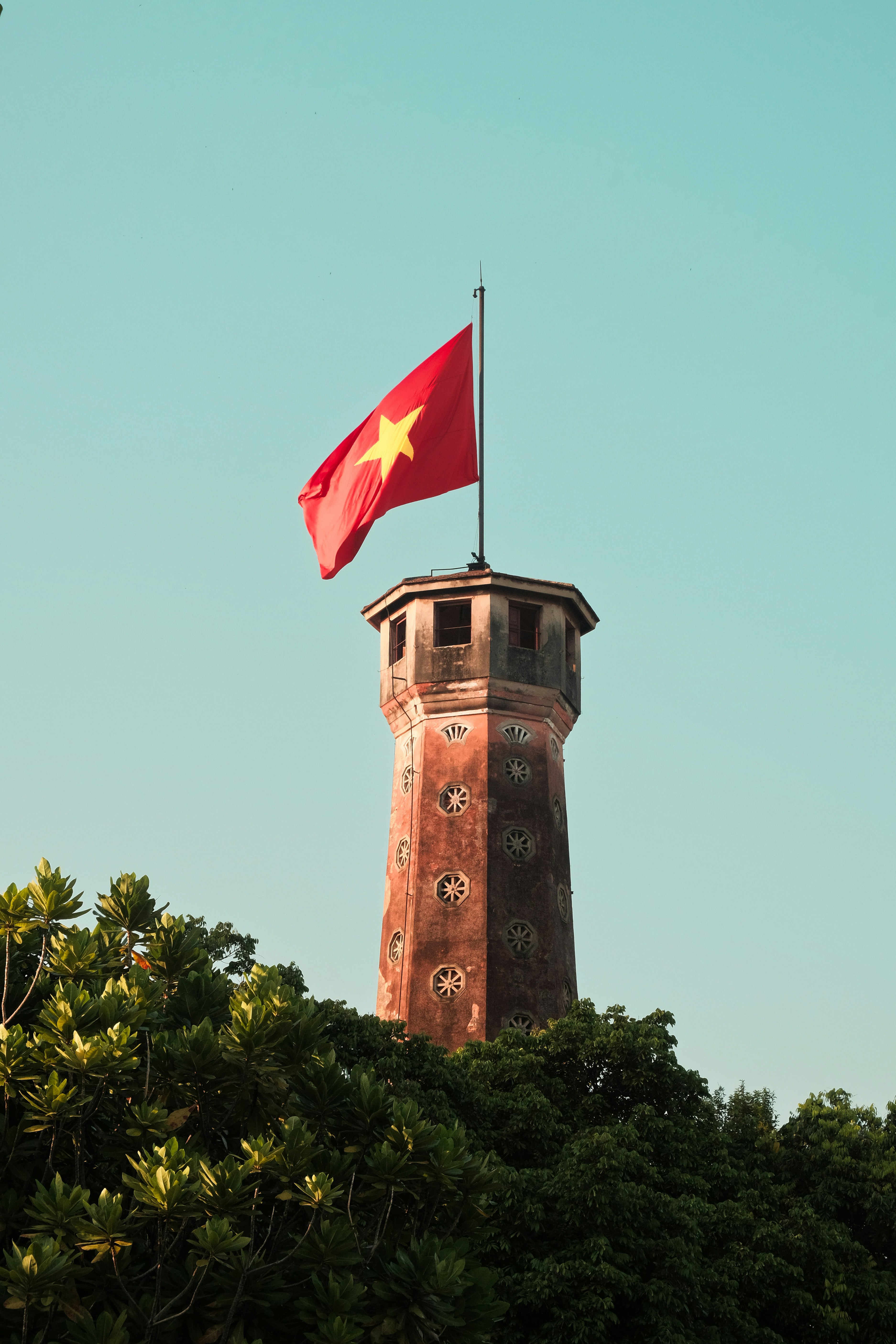 A tower with a flag on top of it