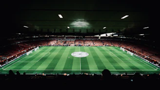 A large stadium with a green field in the middle of it
