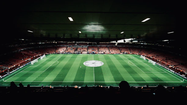 A large stadium with a green field in the middle of it