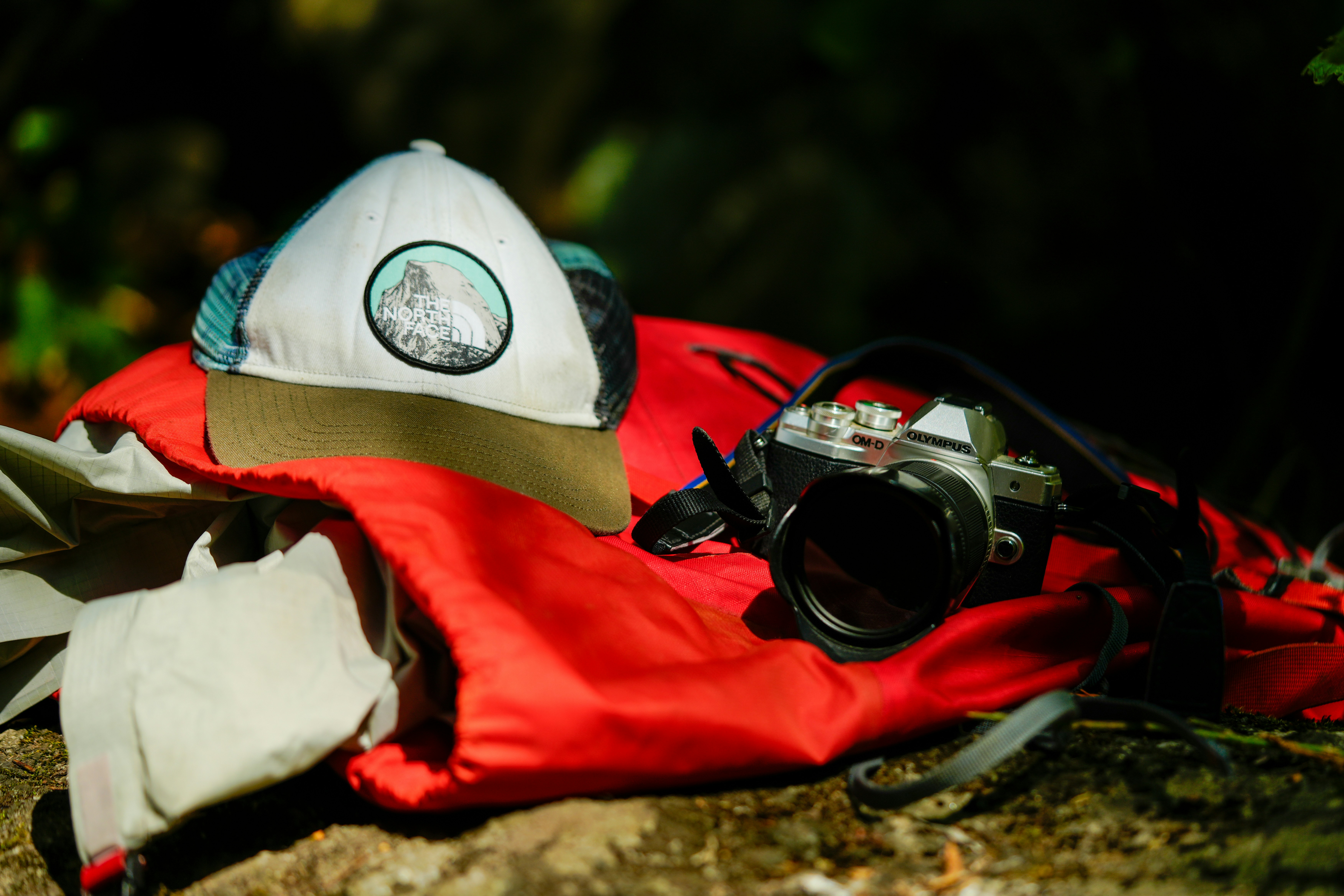 Mountain first aid kit, Hiker resting on trail, Pine forest landscape, Wilderness emergency gear, ilustrasi artikel Essential Wilderness First Aid: A Beginner’s Guide for Outdoor Enthusiasts 5