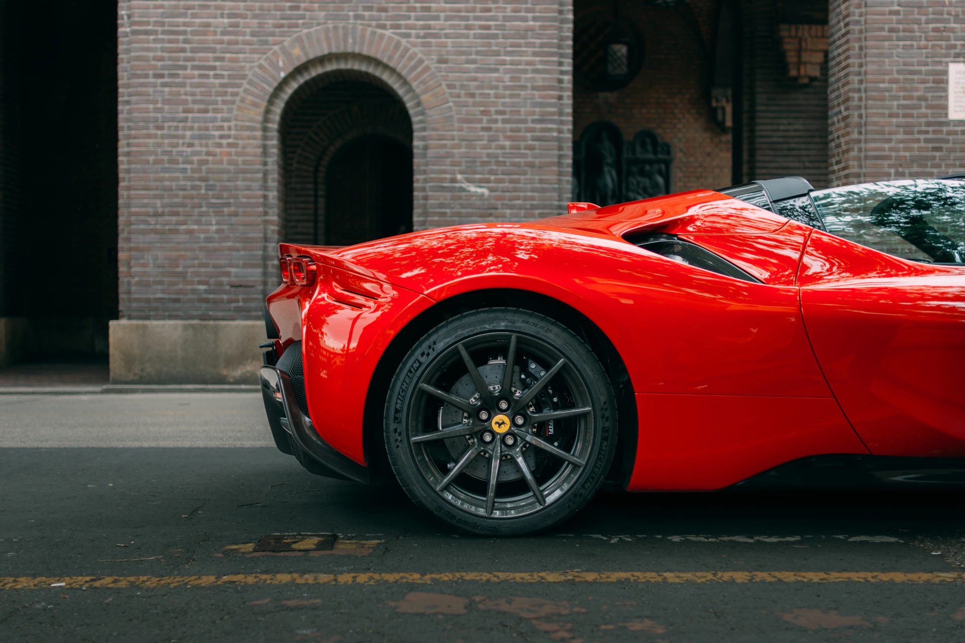 A red sports car parked on the side of the road