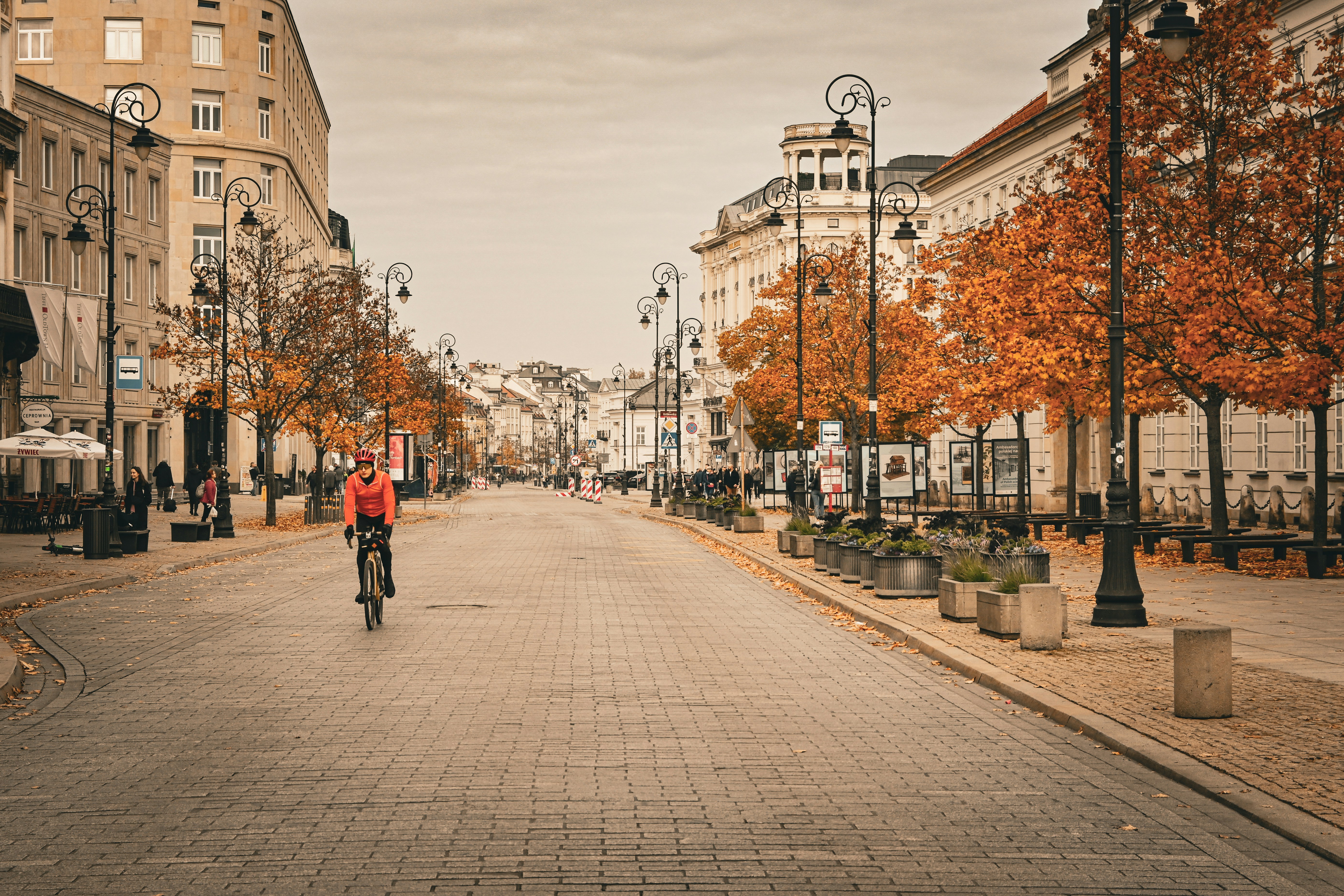 A man riding a bike down a street next to tall buildings