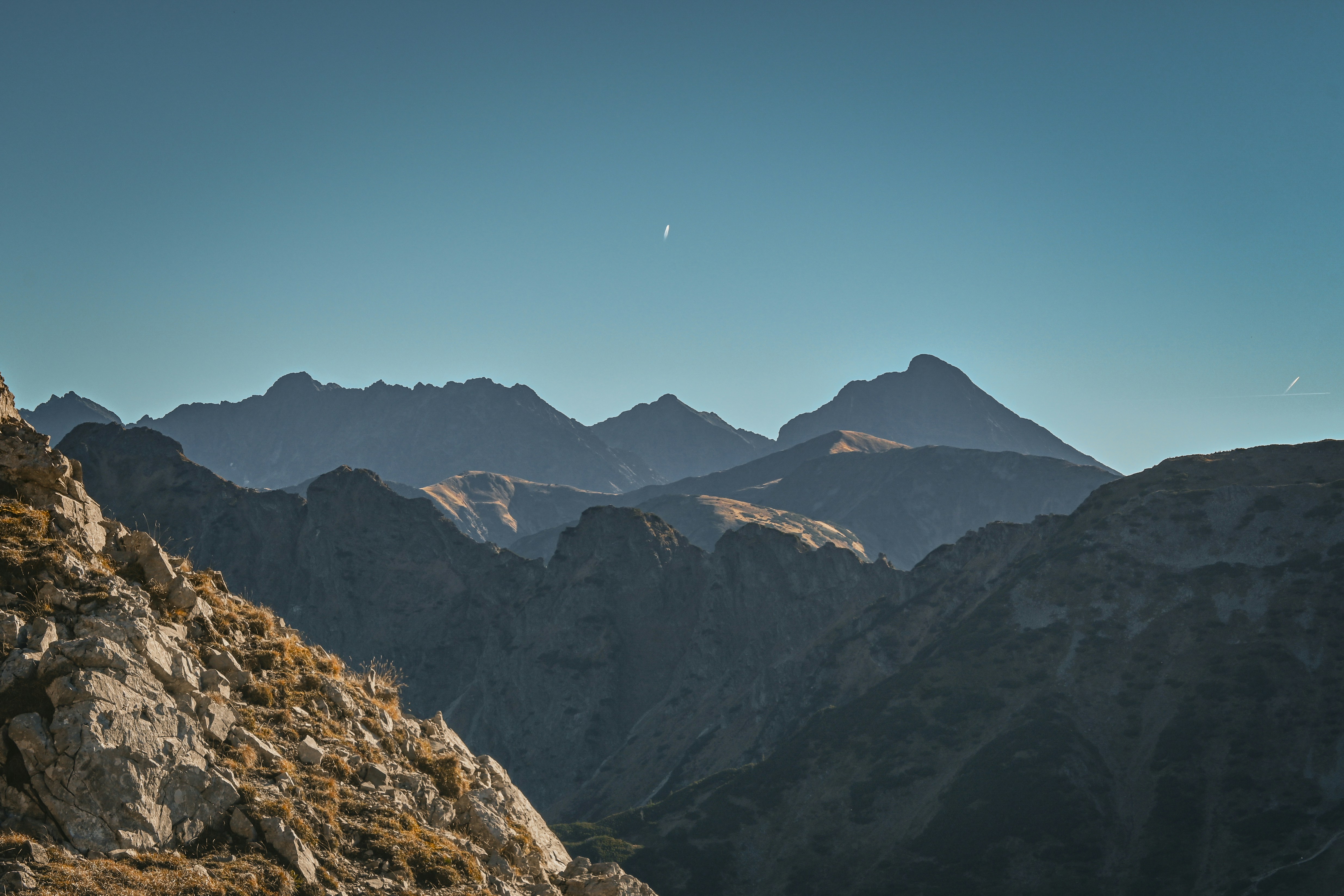 A person standing on top of a rocky mountain
