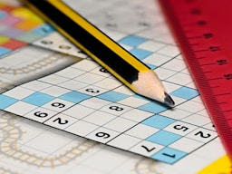 A pencil sitting on top of a piece of paper next to a ruler