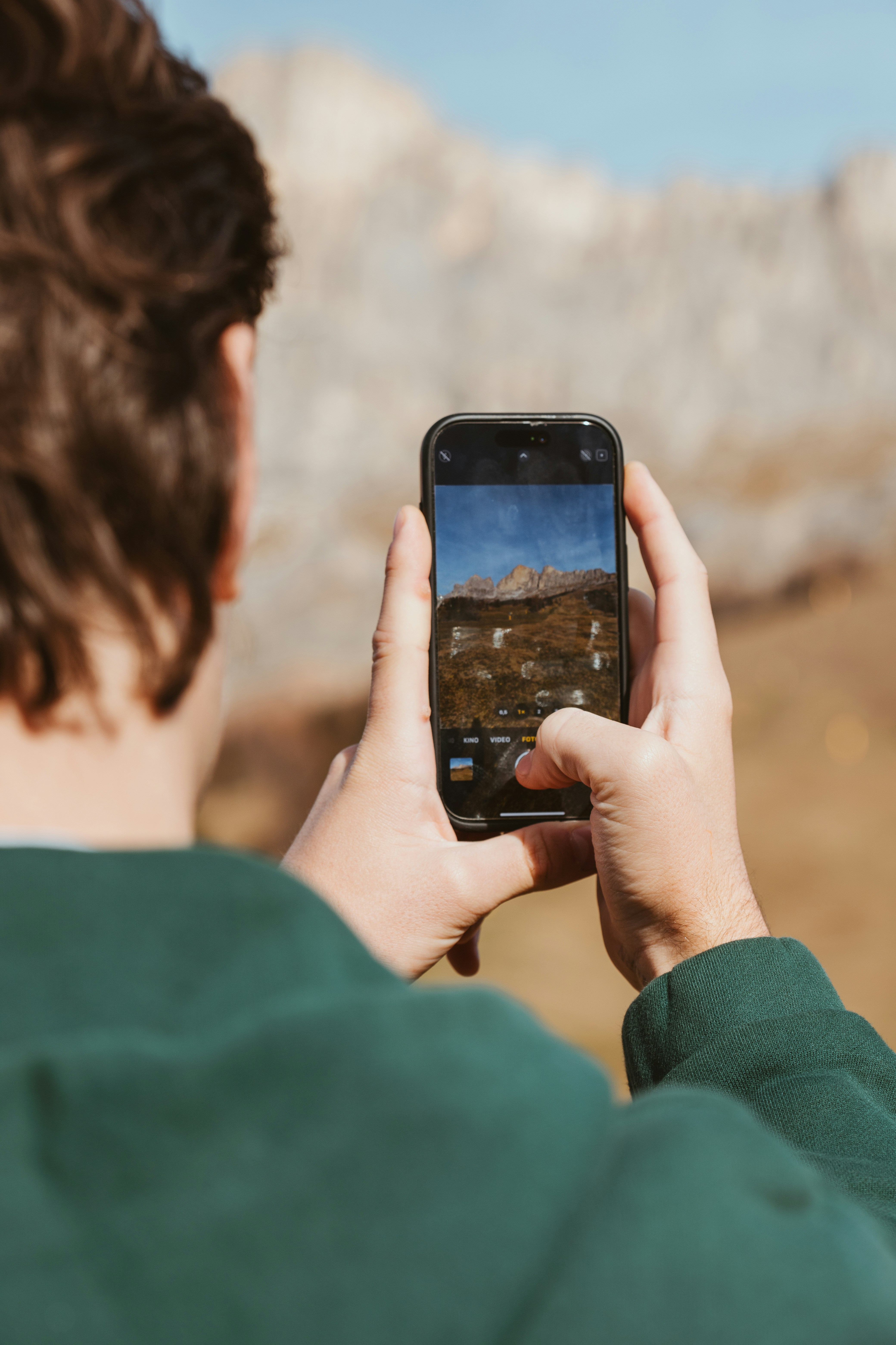 A person taking a picture with a cell phone