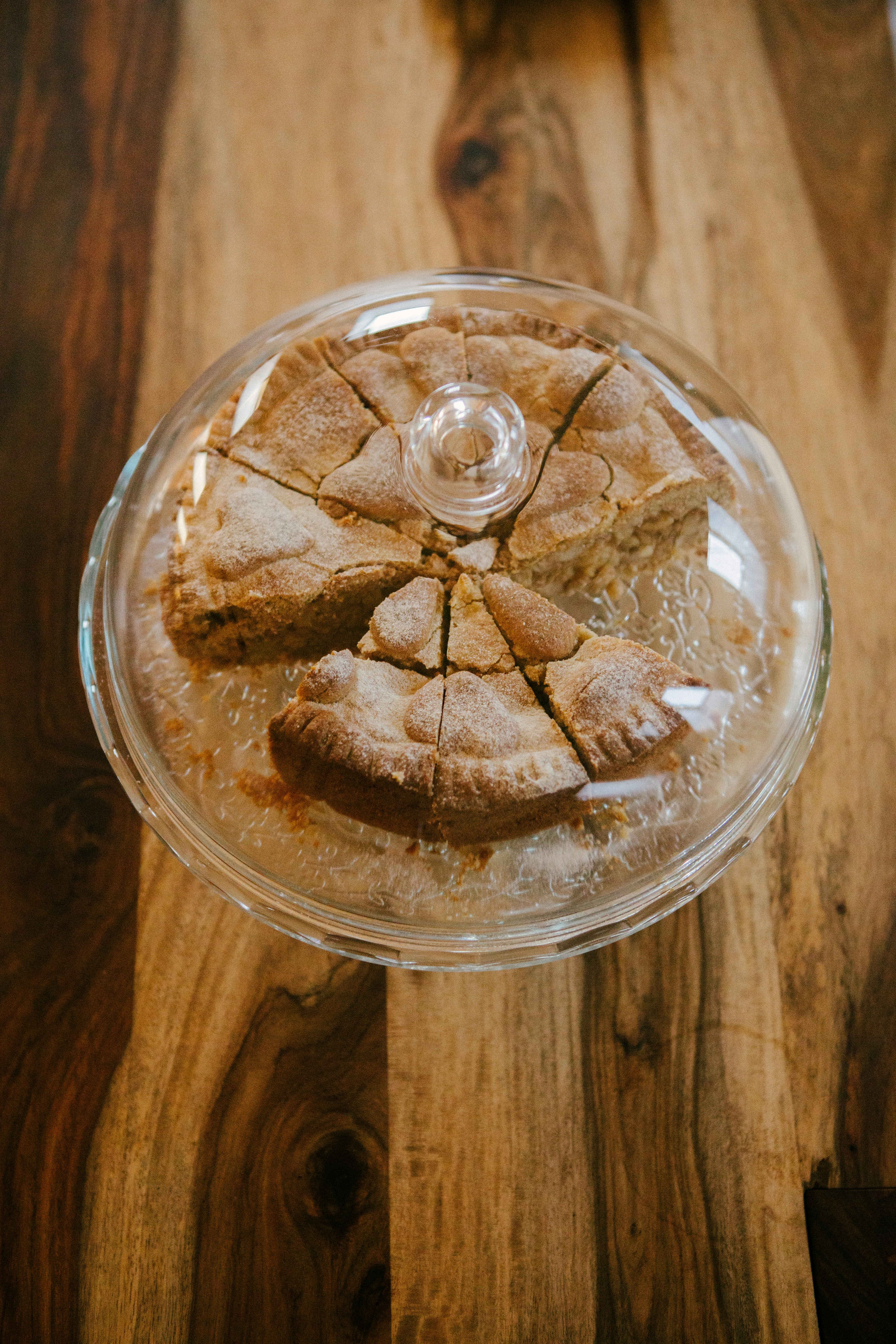 A glass plate with a piece of pie on top of it