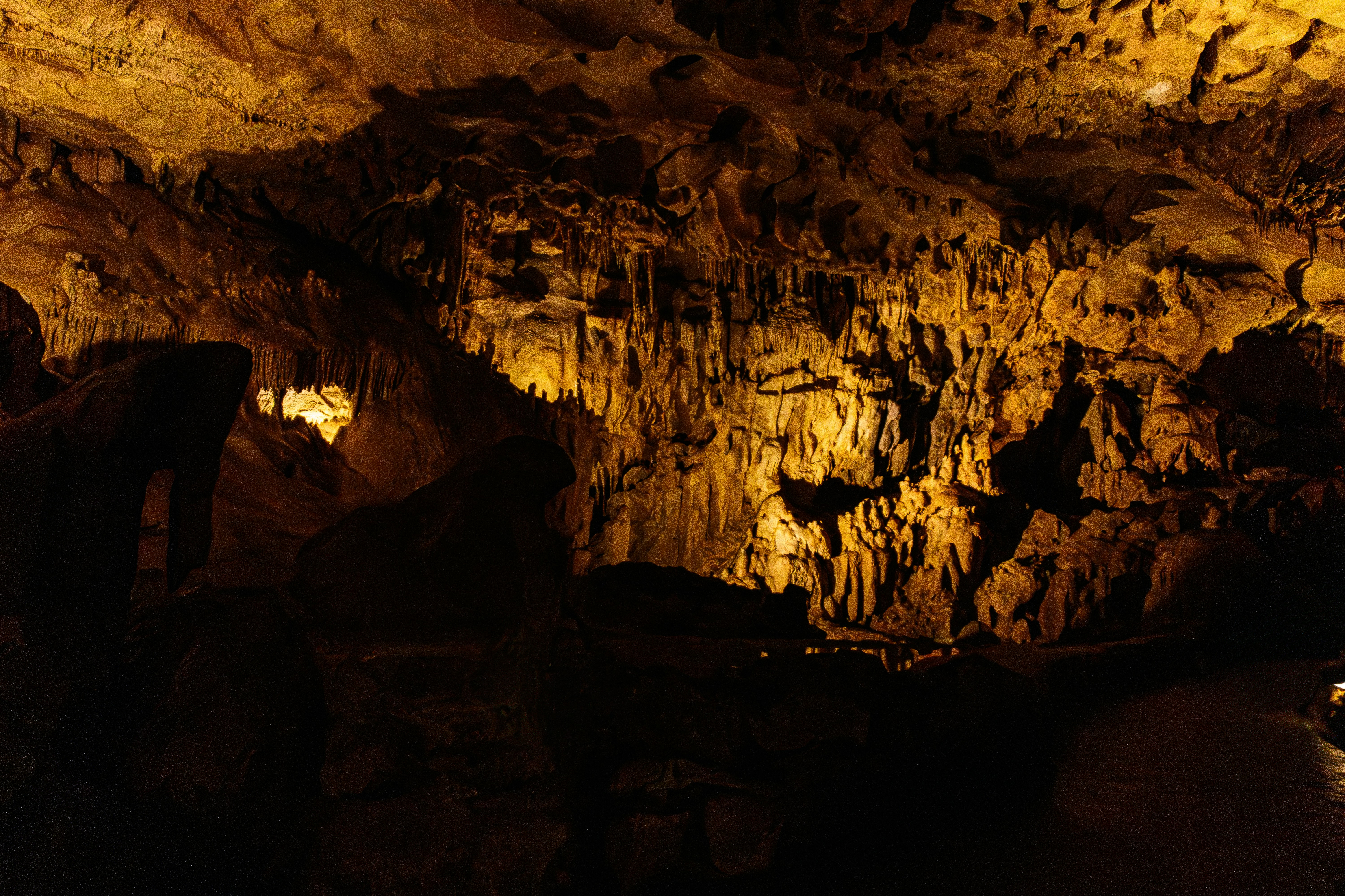A group of people standing inside of a cave