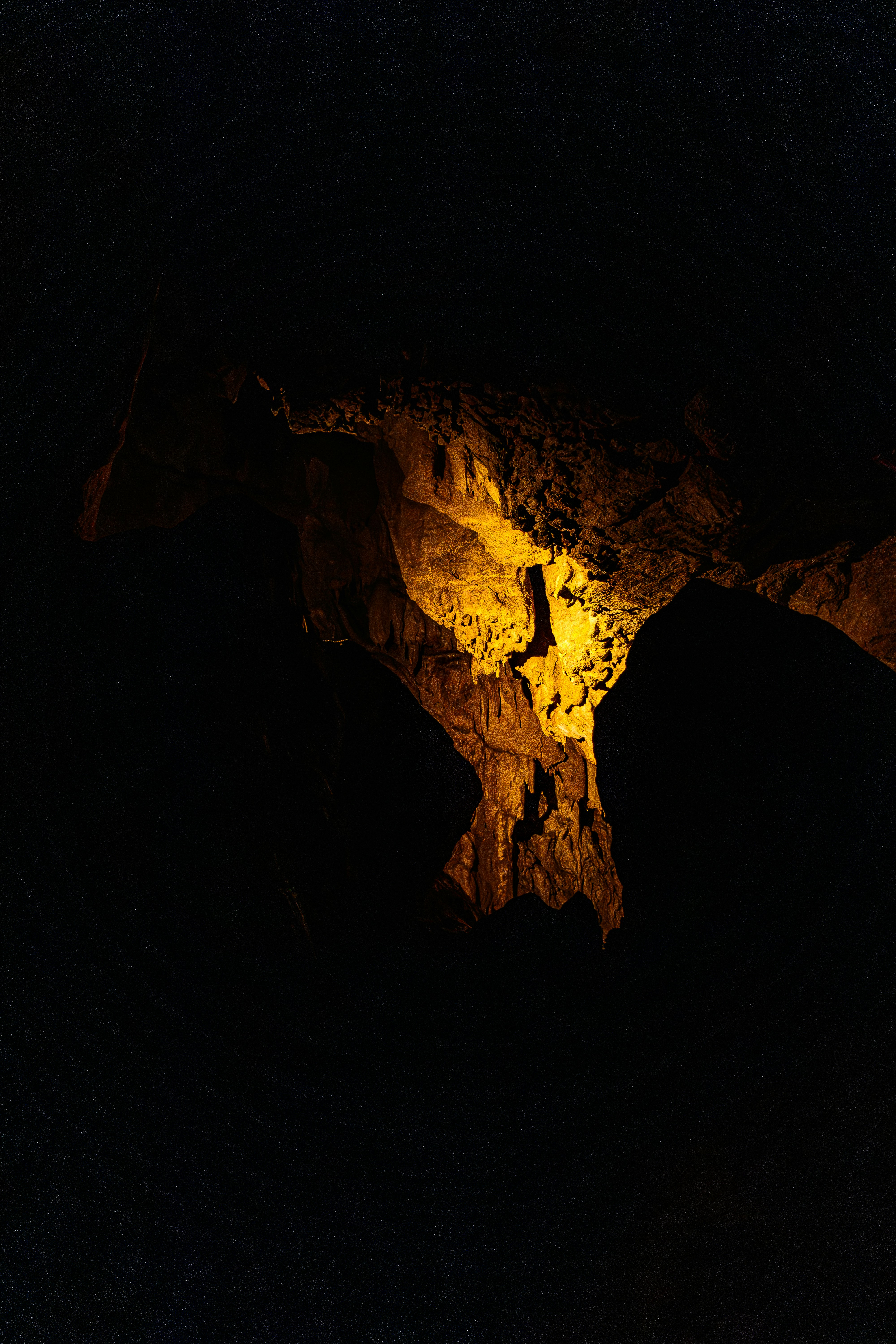 Volumetric amber light shaft in dark cave