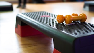 A close up of a table with two oranges on it