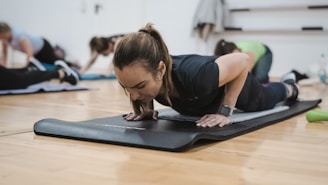 A group of people in a gym doing push ups