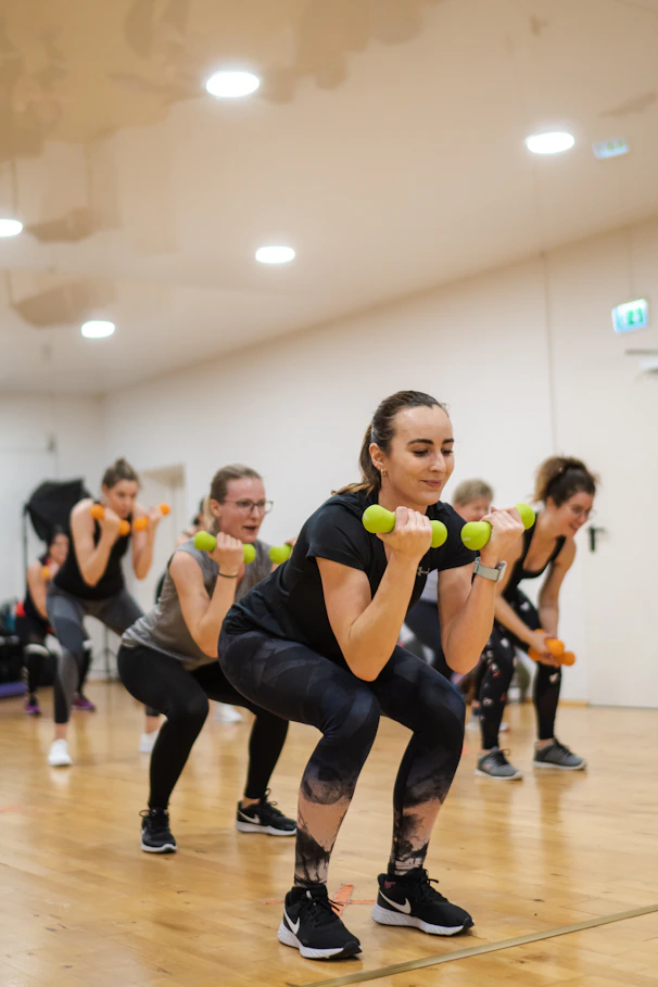 A group of women doing exercises with dumbbells