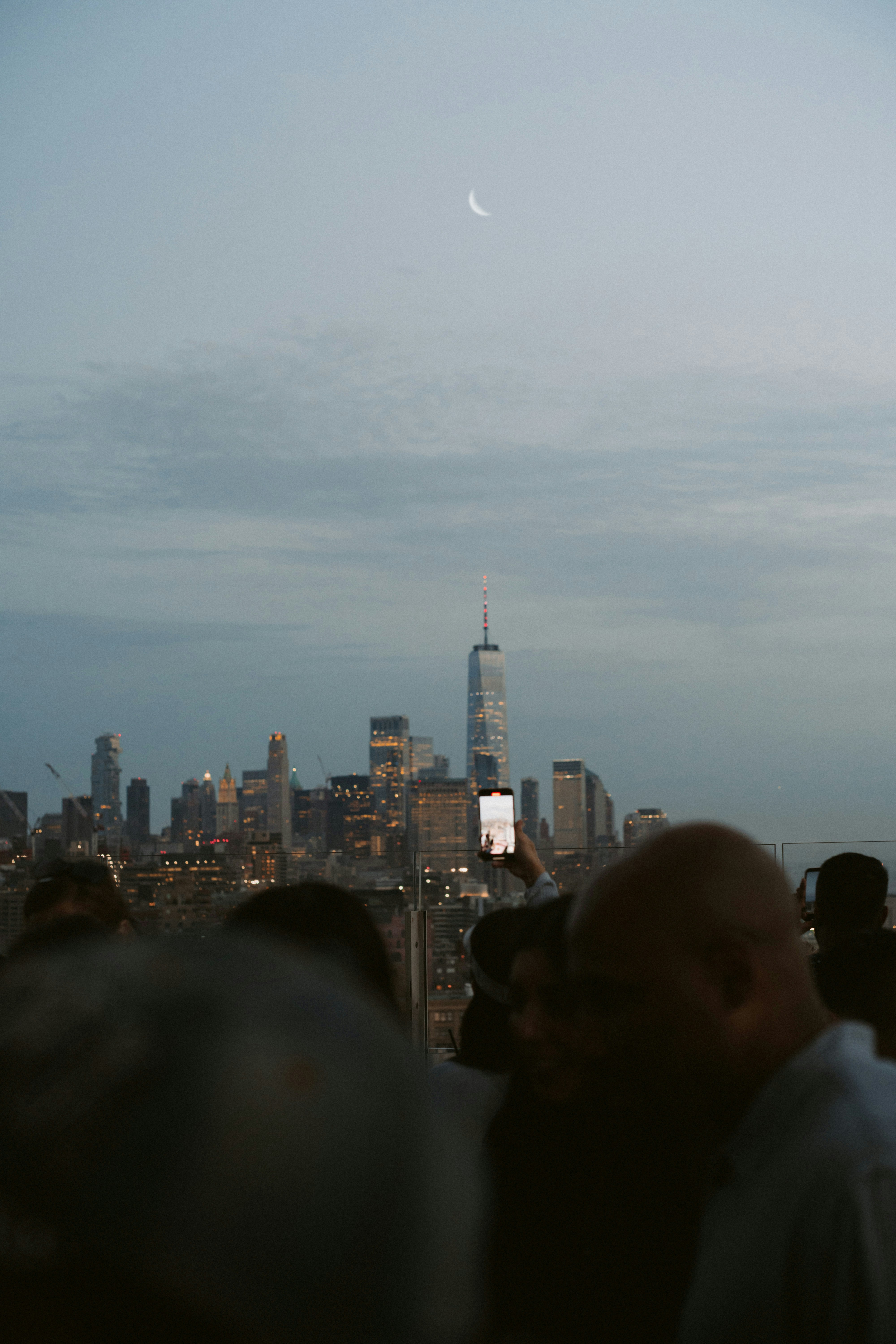 A group of people standing on top of a tall building