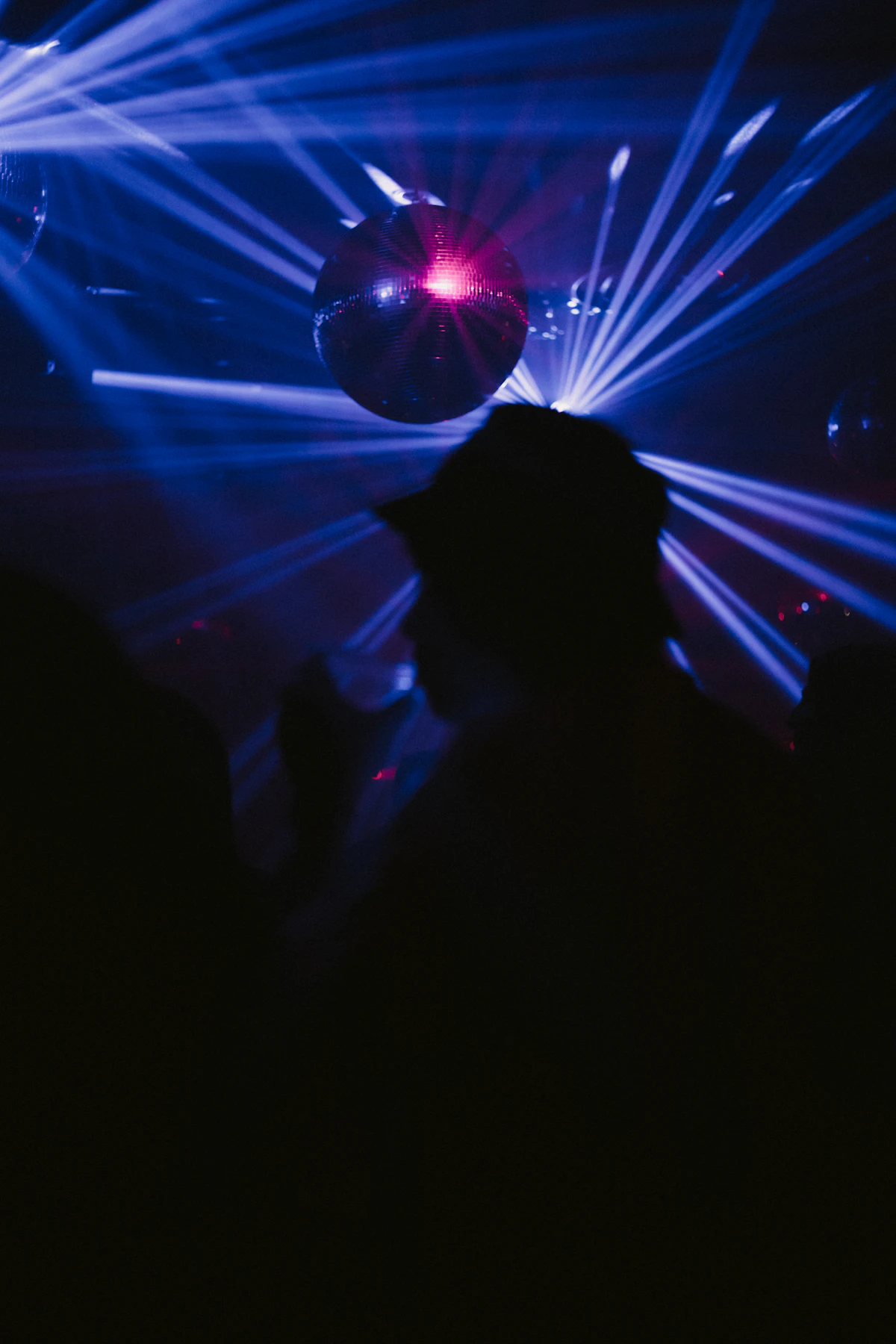 A crowd silhouetted by blue and pink club lights at Le Bain in New York