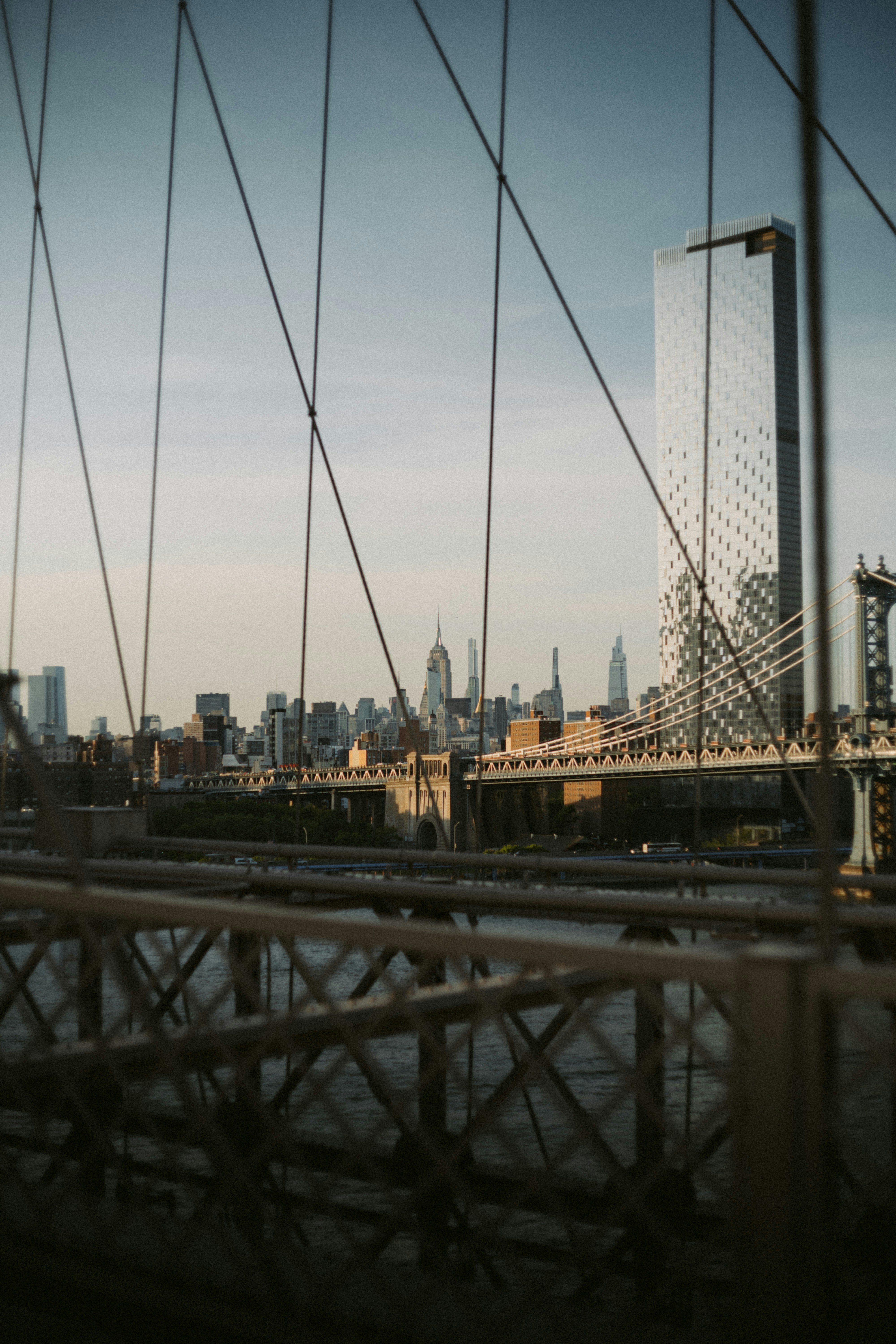 A view of a bridge with a city in the background