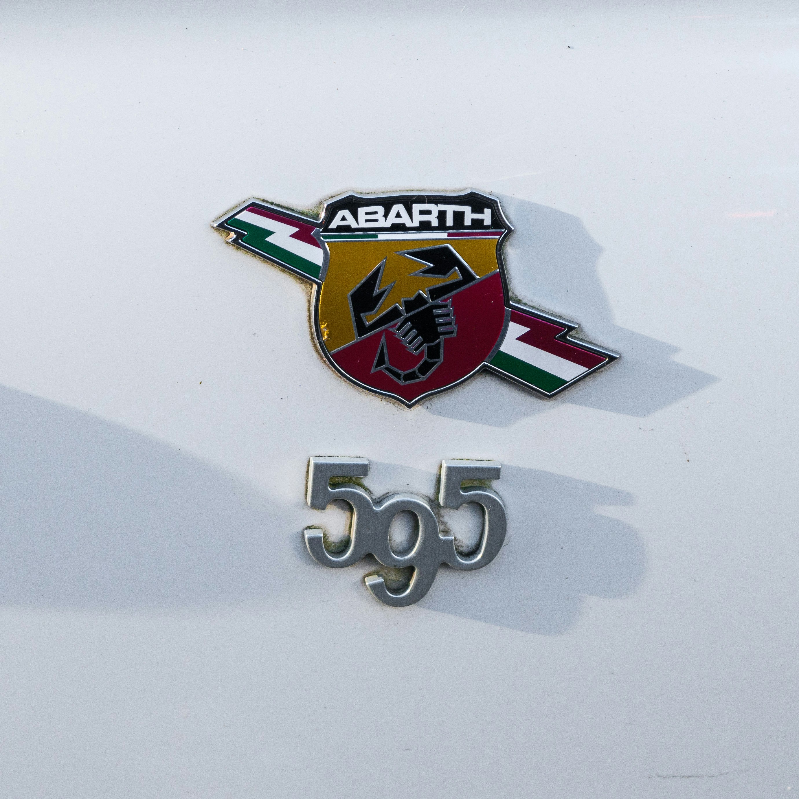 A close up of the emblem on a white car