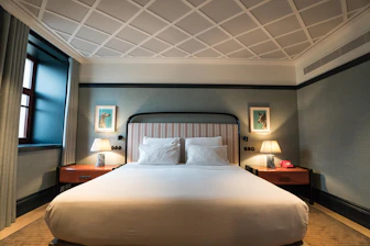 A large bed sitting in a bedroom next to a window