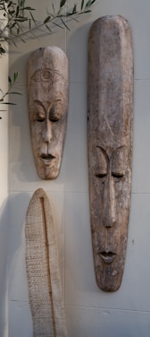 A couple of masks hanging on a wall
