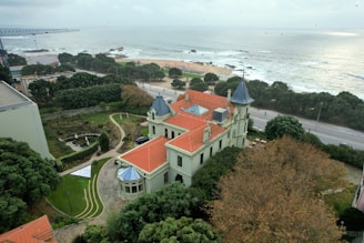 An aerial view of a large building with a red roof
